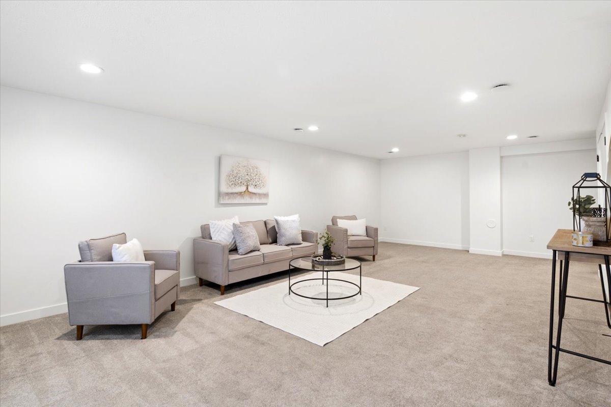 Spacious room featuring neutral carpeting, recessed lighting, white walls, and white trim