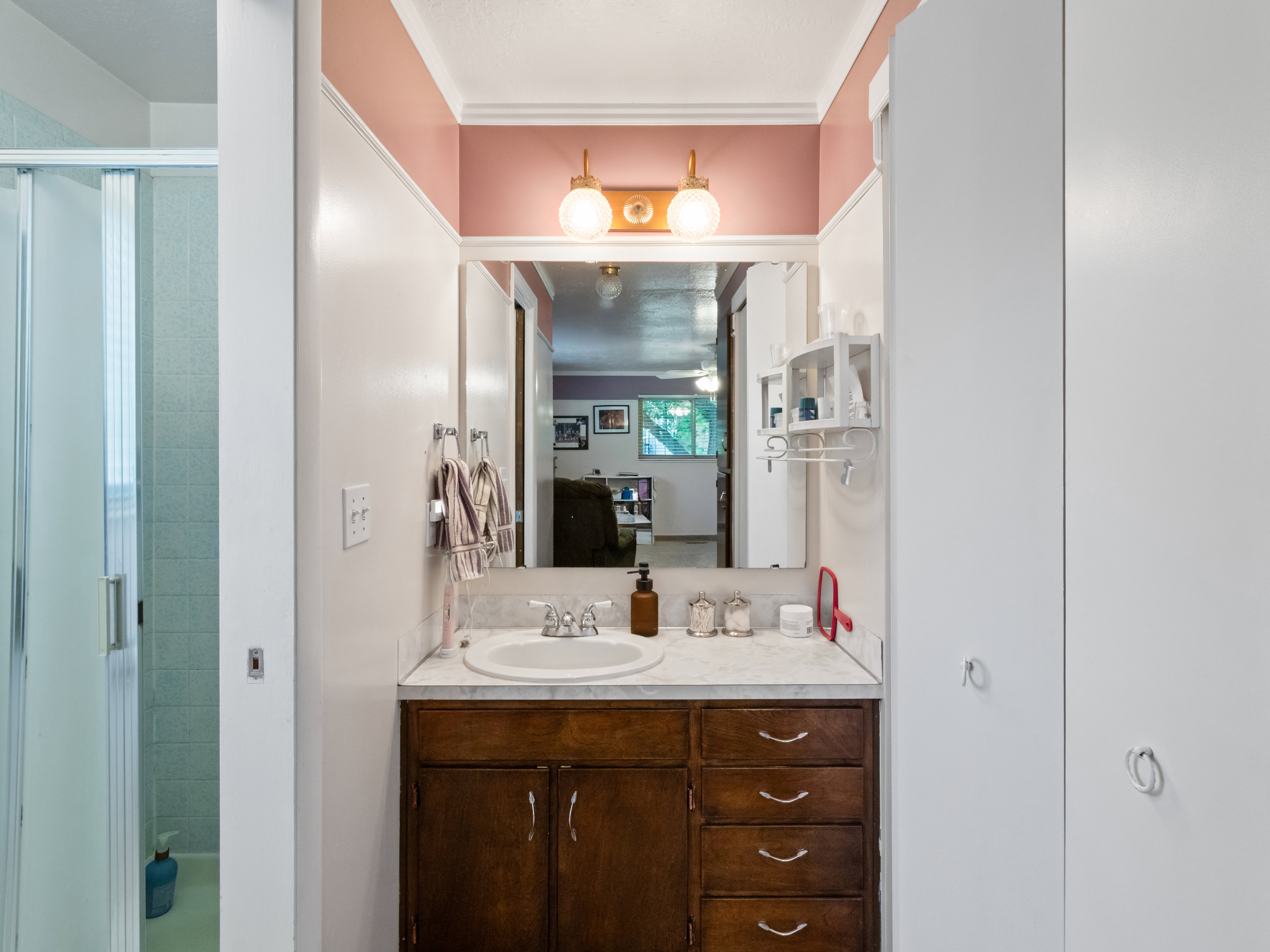 Vanity area featuring a single basin sink with chrome fixtures and a stone-finish countertop