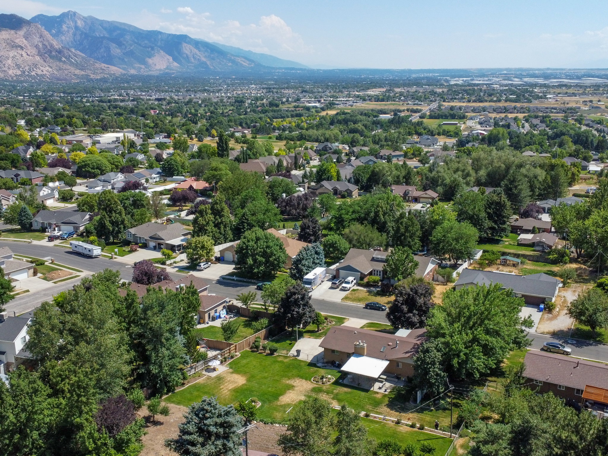 Expansive neighborhood with diverse residential architecture and mature landscaping