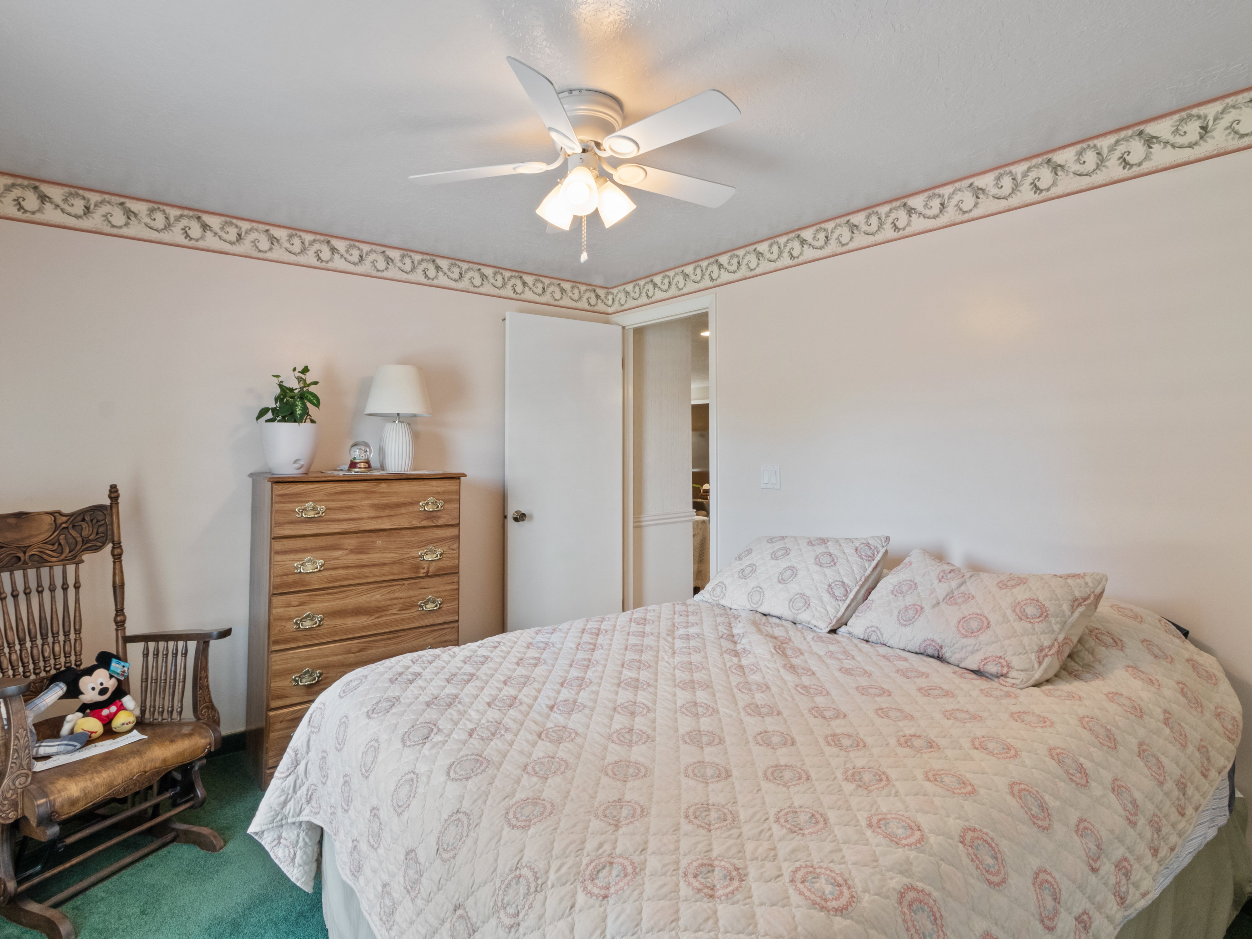 Interior room featuring wall-to-wall carpeting and a ceiling fan