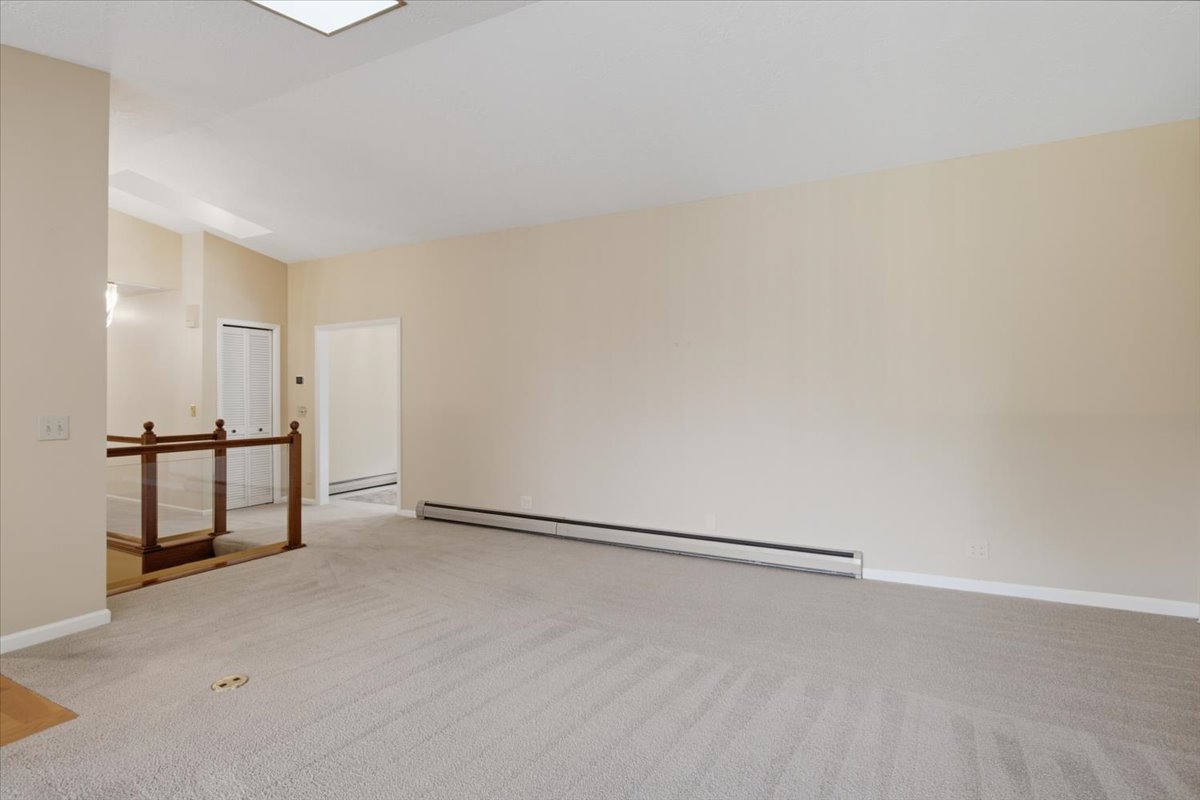 Spacious interior featuring neutral carpeting and light-toned walls