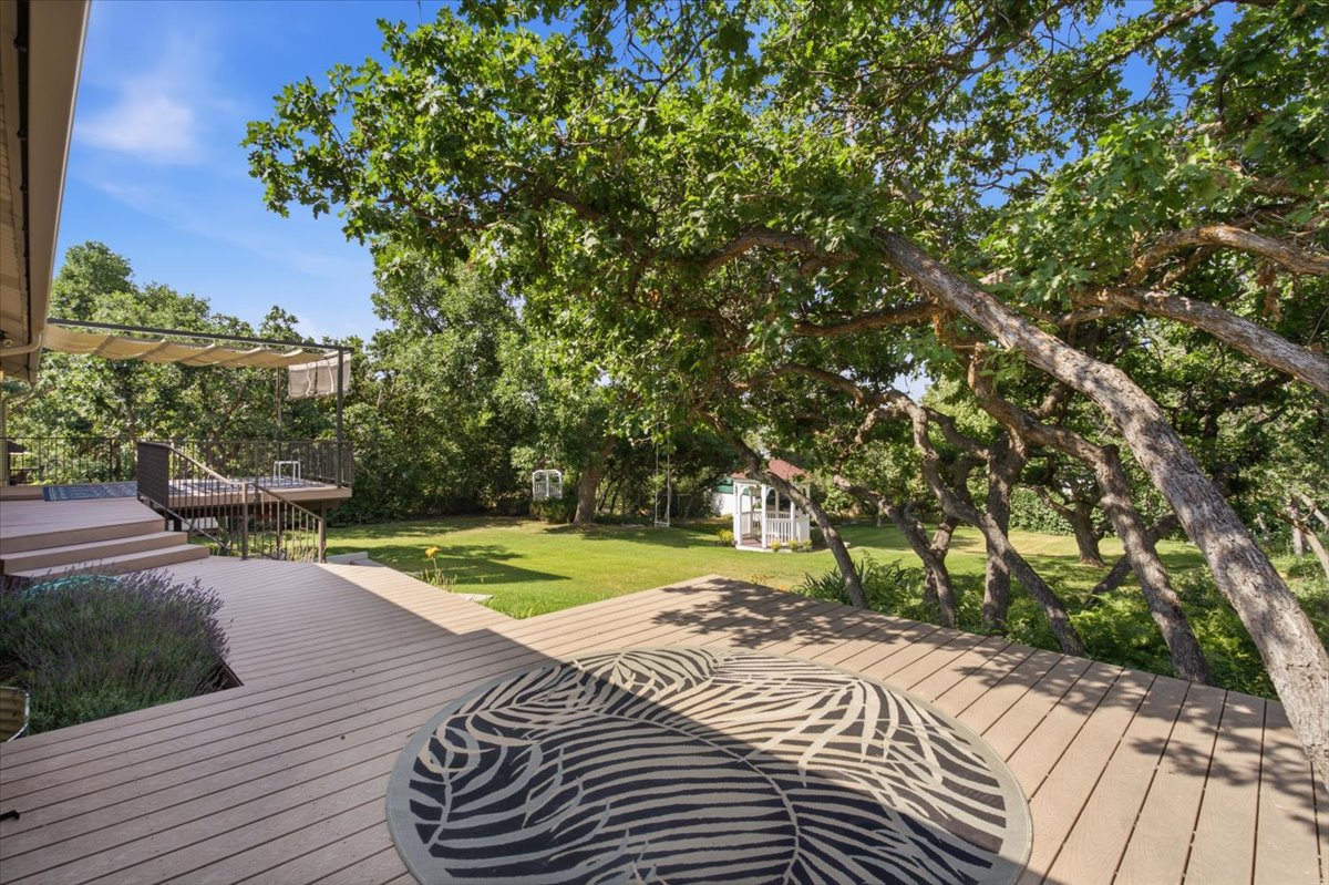 Expansive composite decking featuring multiple tiers and an integrated planter