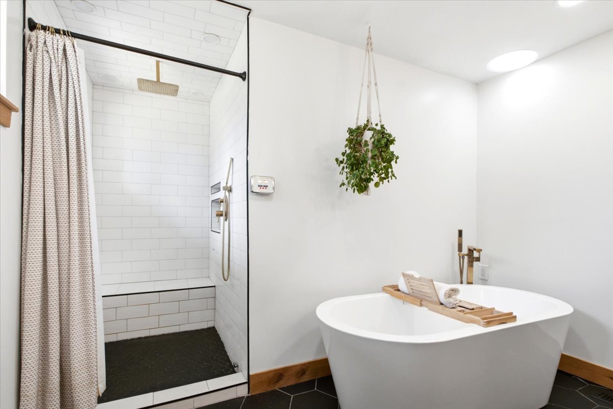 Contemporary bathroom featuring a freestanding soaking tub and a walk-in shower with a built-in bench