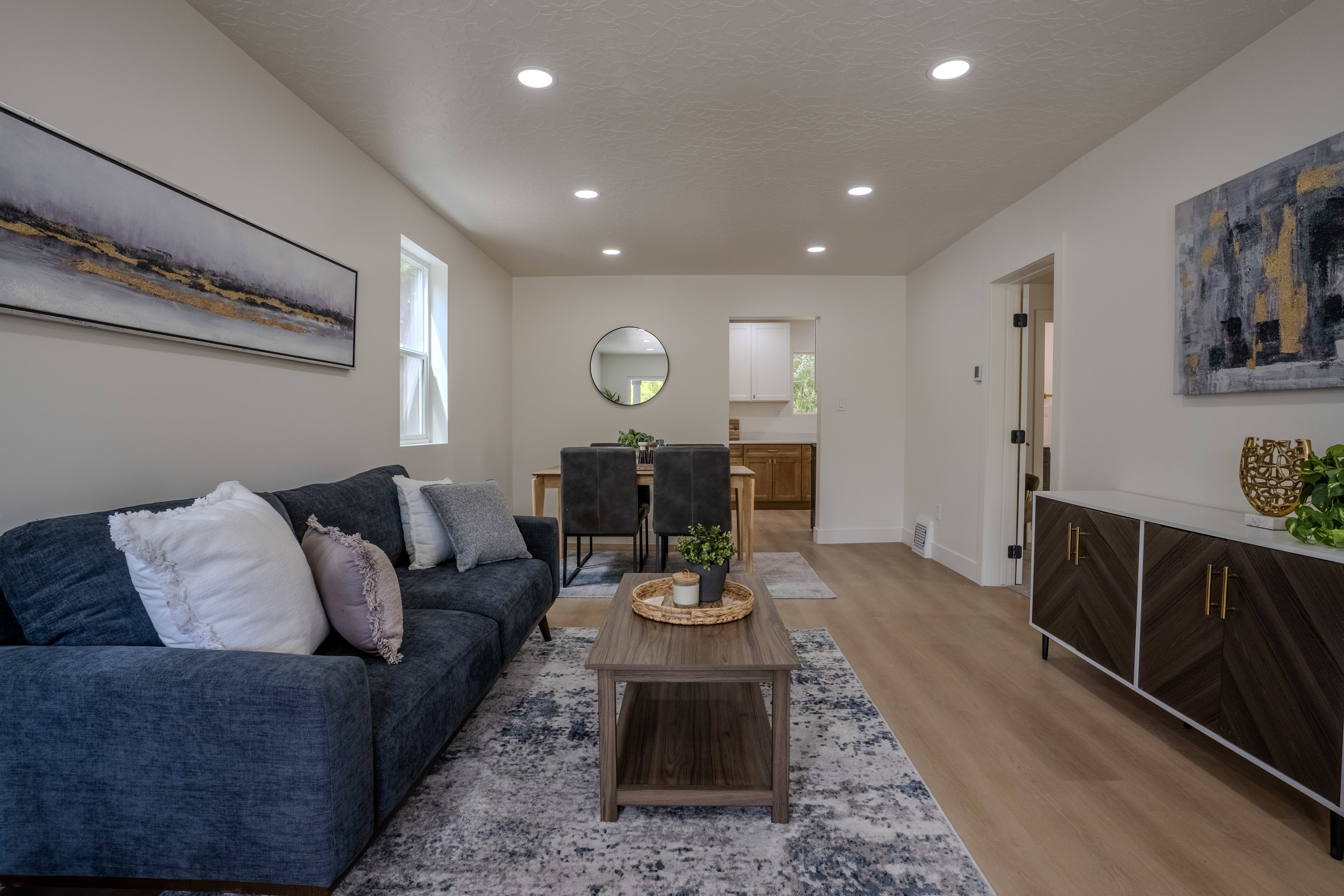 Open-concept living space featuring recessed lighting, light-toned walls, and wood-finish flooring
