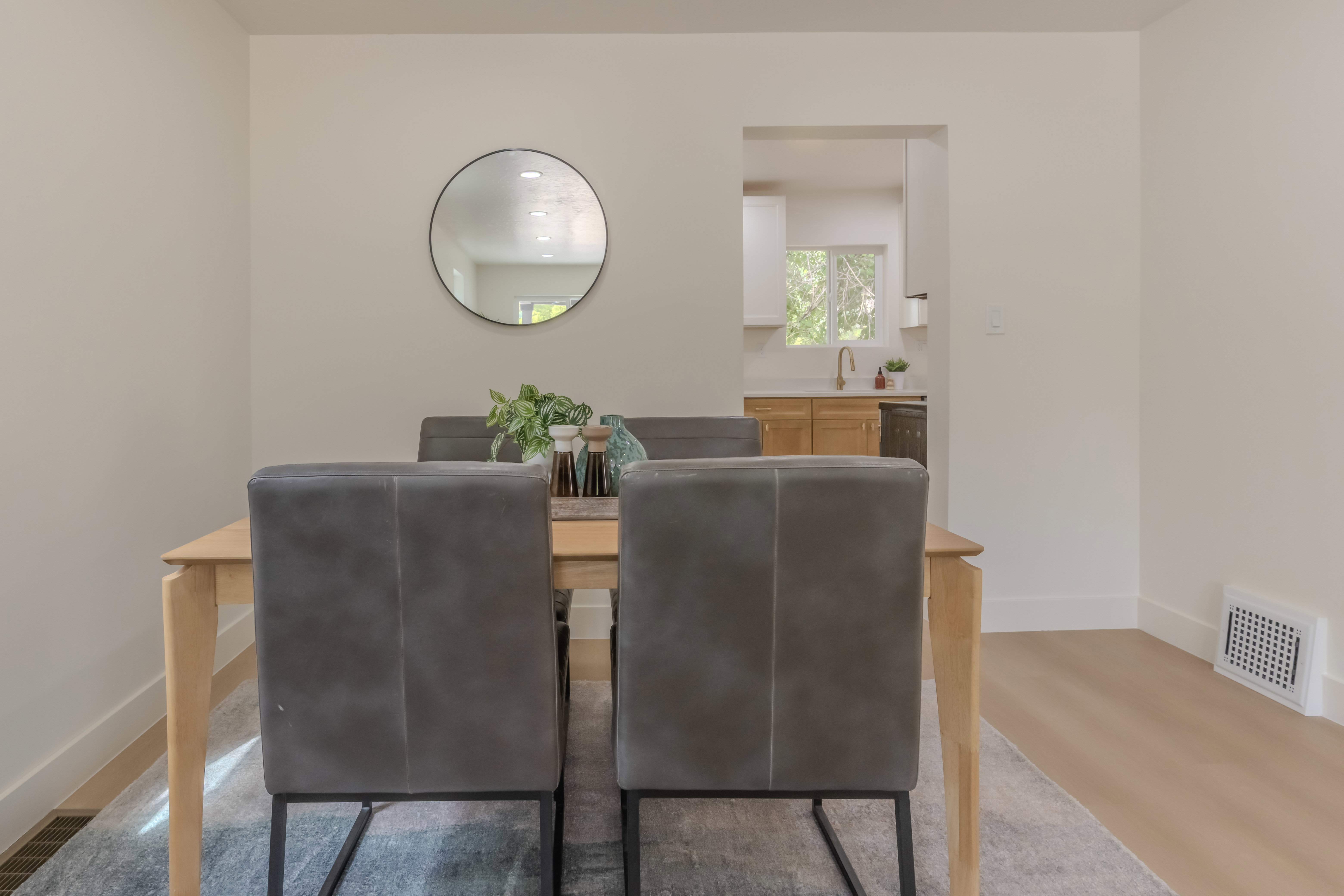 Dining area with light-toned wood-finish flooring