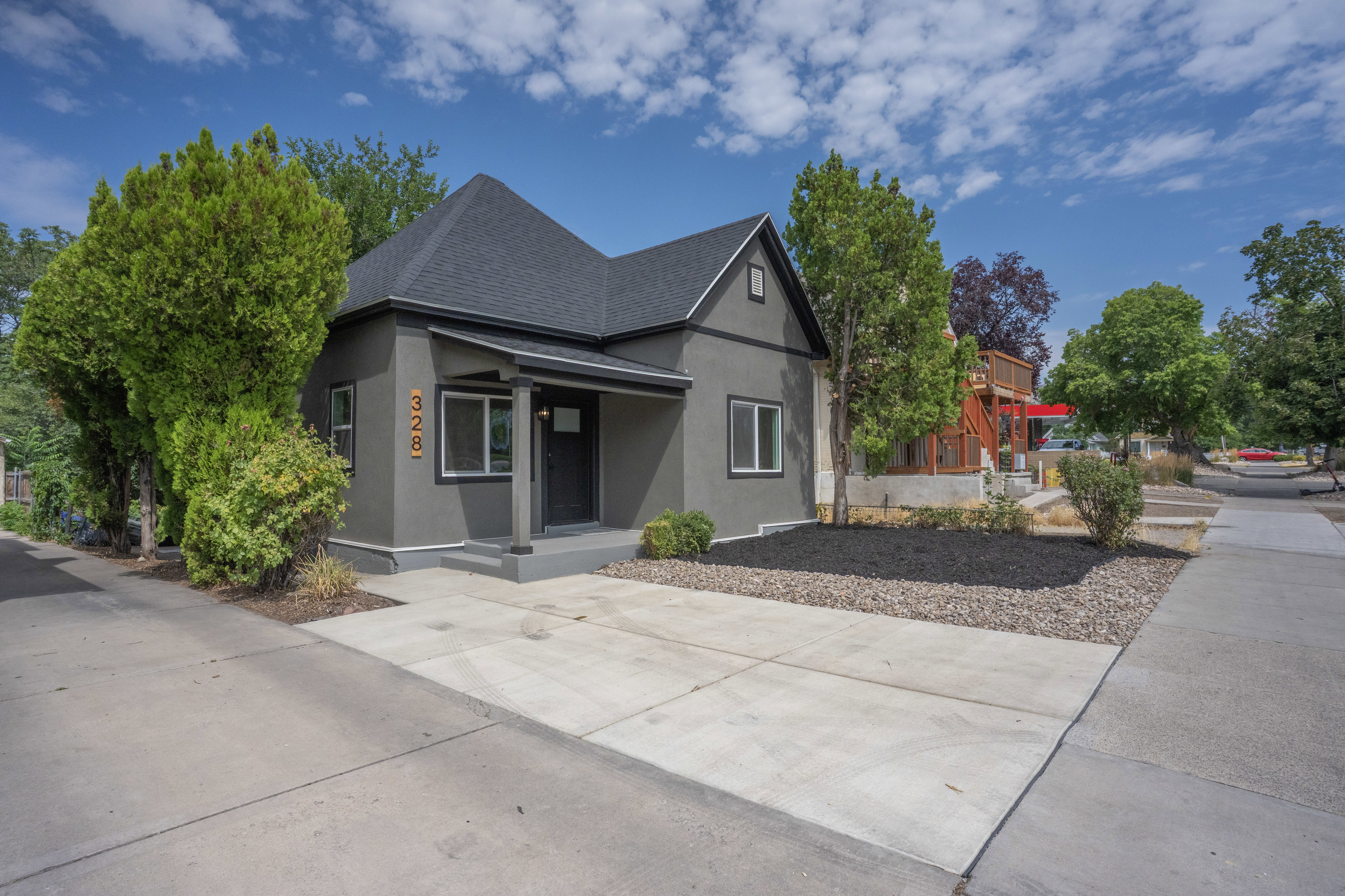 Contemporary stucco exterior with dark trim windows