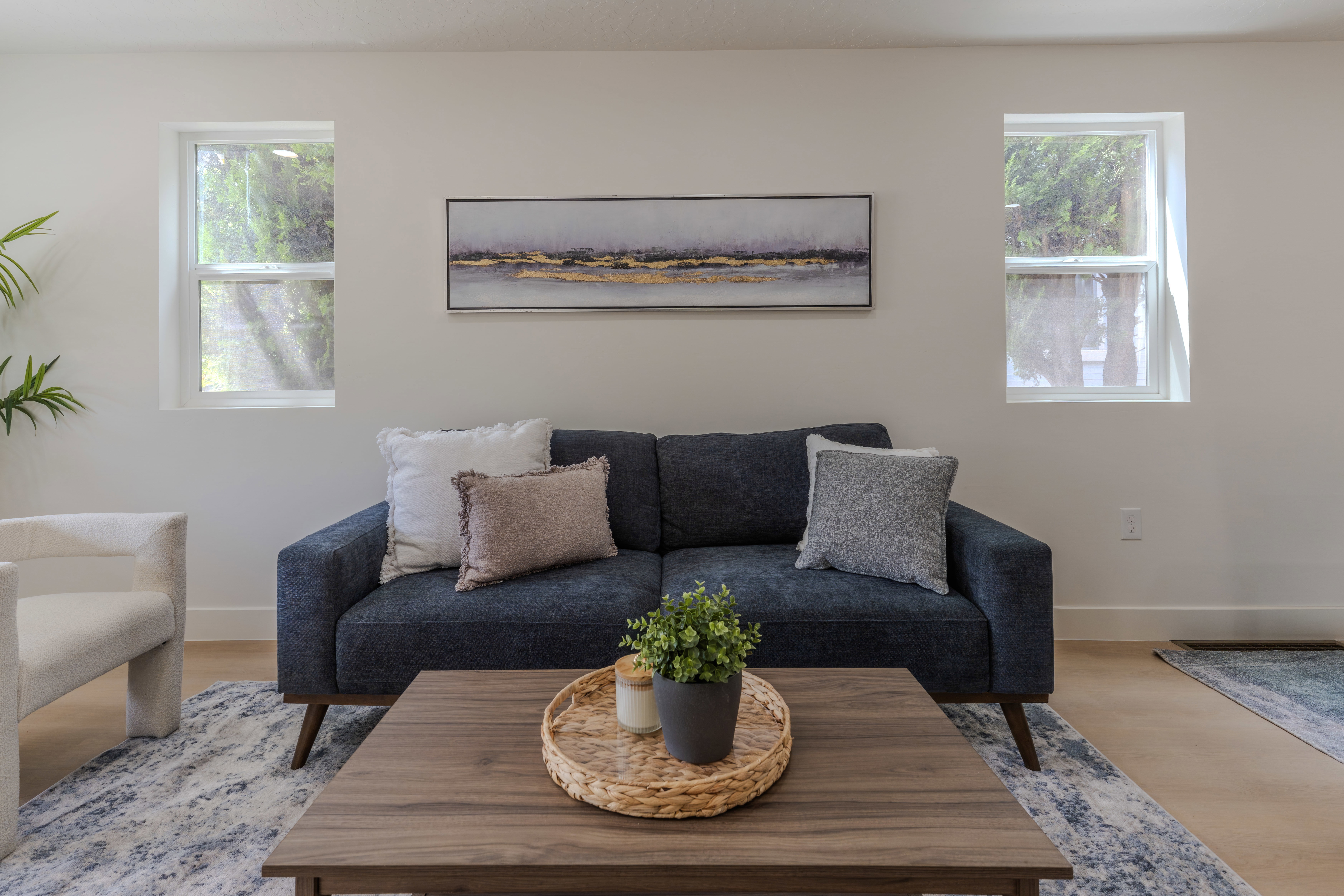 Bright interior space featuring light-toned wood-finish flooring and neutral wall paint