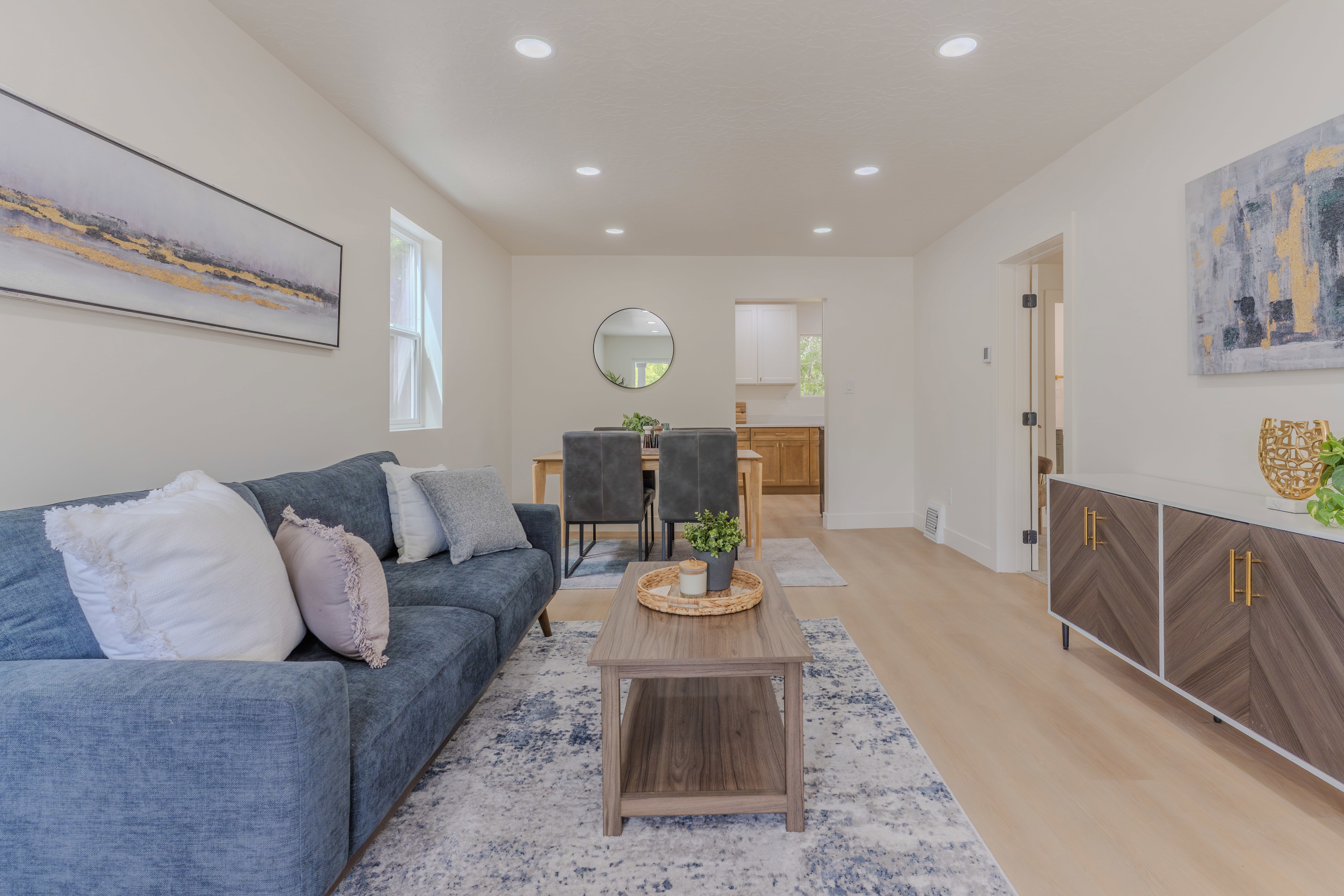 Bright living area featuring recessed lighting and wood-finish flooring