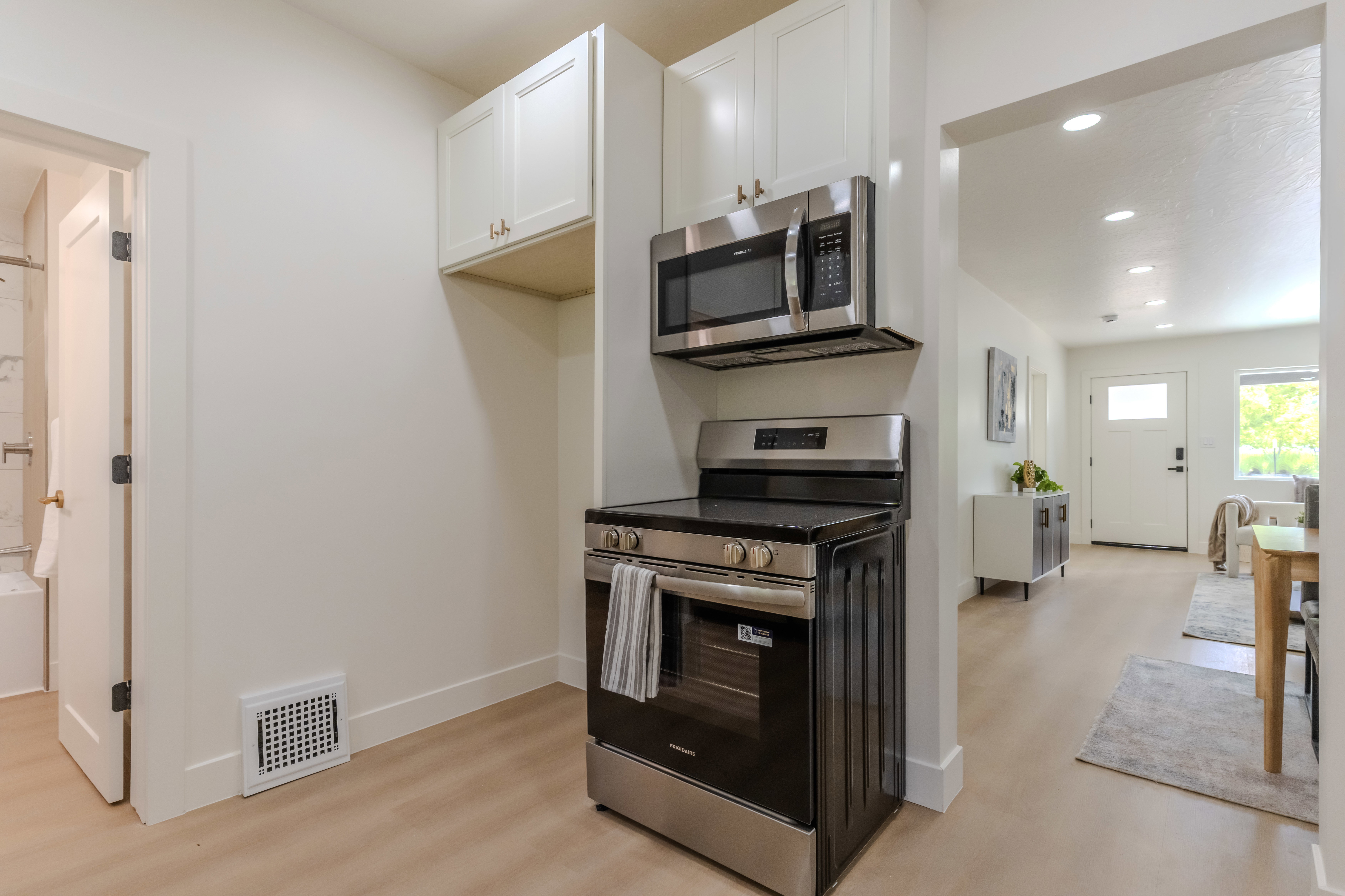 Kitchen area featuring stainless steel appliances, including an electric range and built-in microwave