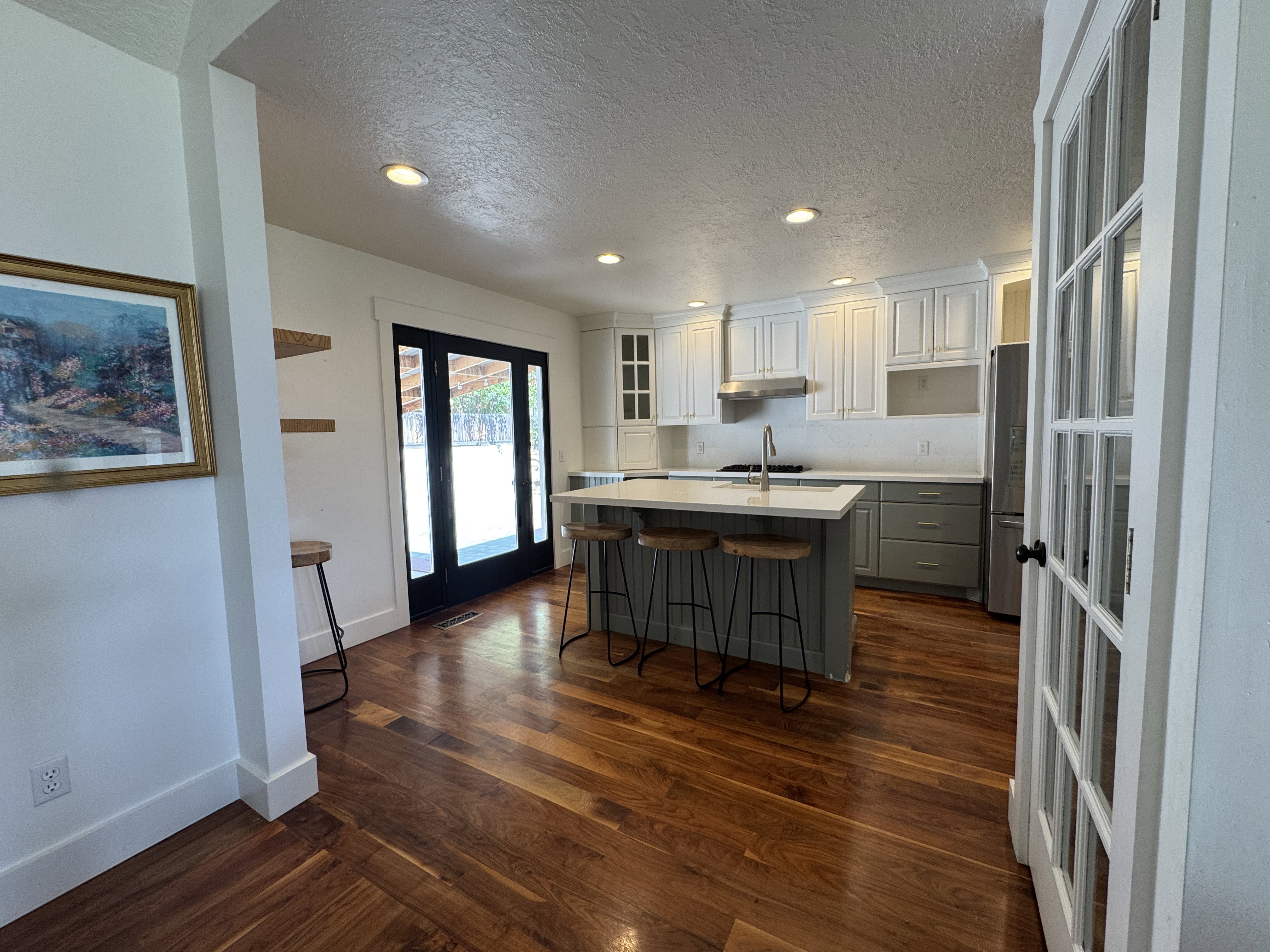 Kitchen featuring wood-finish flooring, recessed lighting, and a center island with a stone countertop