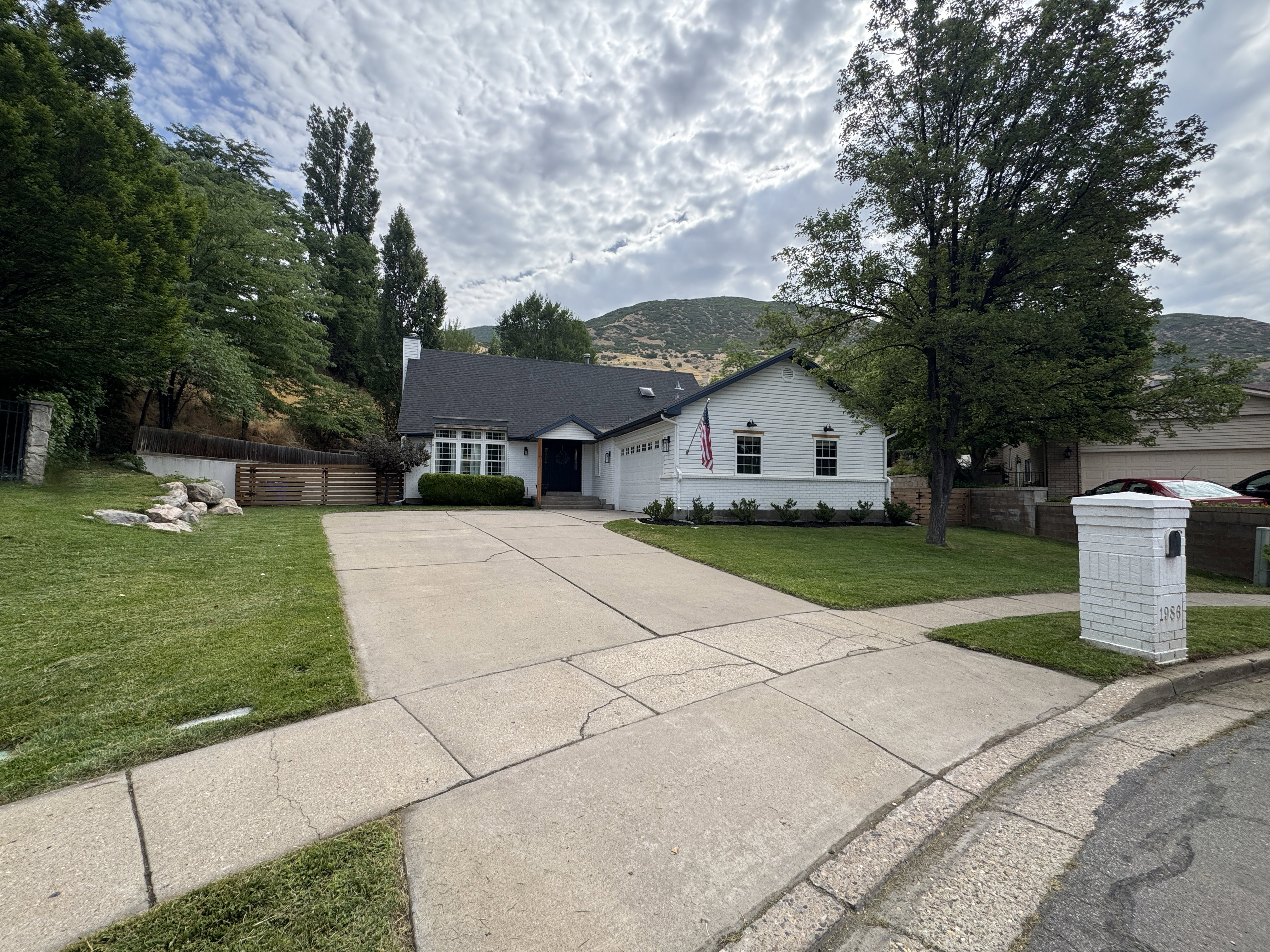 White exterior with dark trim and a dark roof