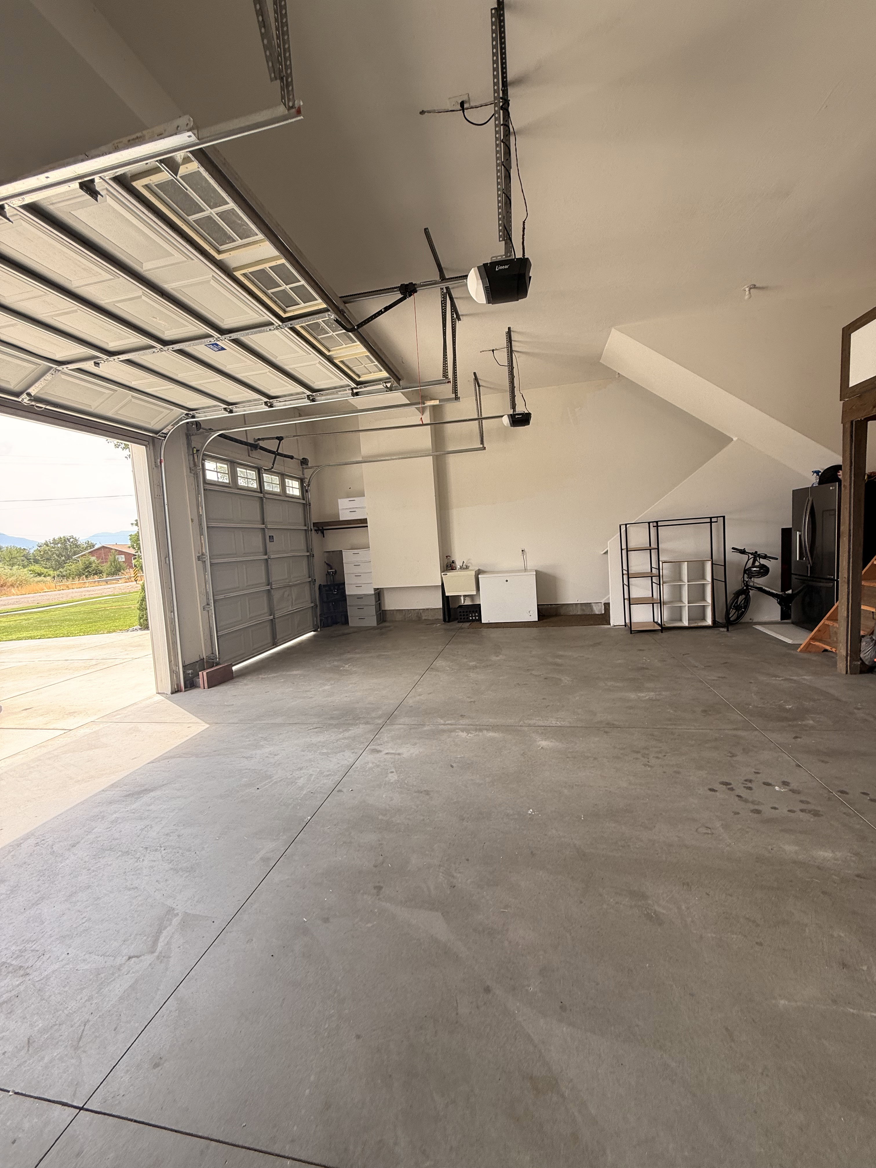 3 car Spacious garage featuring a concrete floor, 3 car garage with extra storage mezzanine