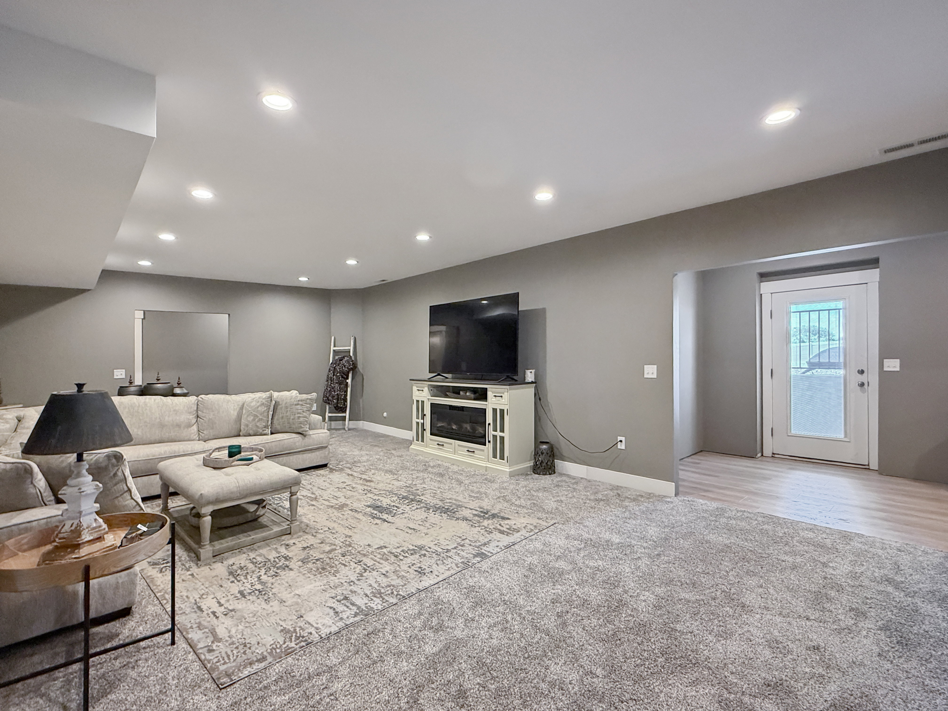 oversized living room in basement with walk out