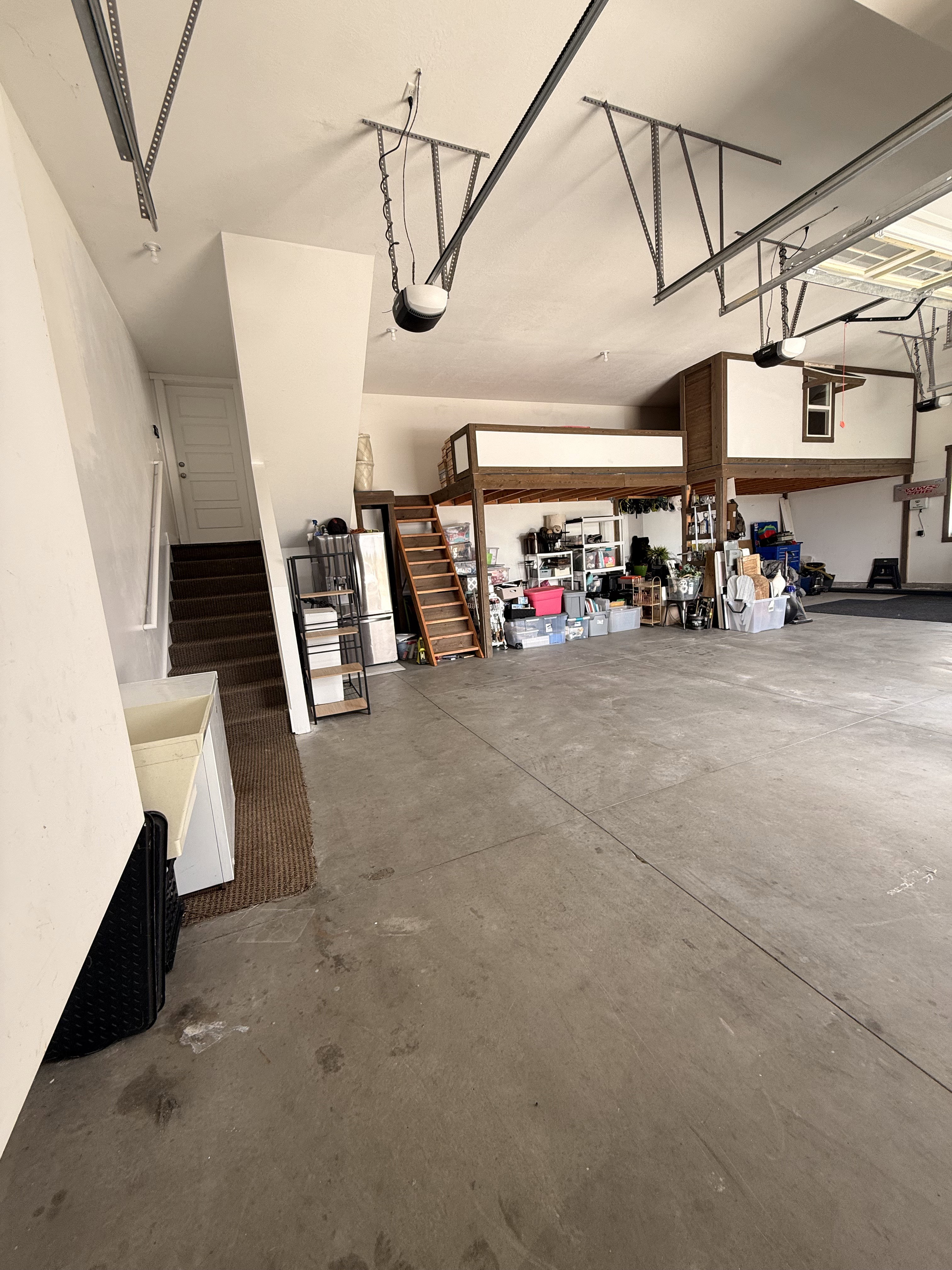 3 car Spacious garage featuring a concrete floor, 3 car garage with extra storage mezzanine
