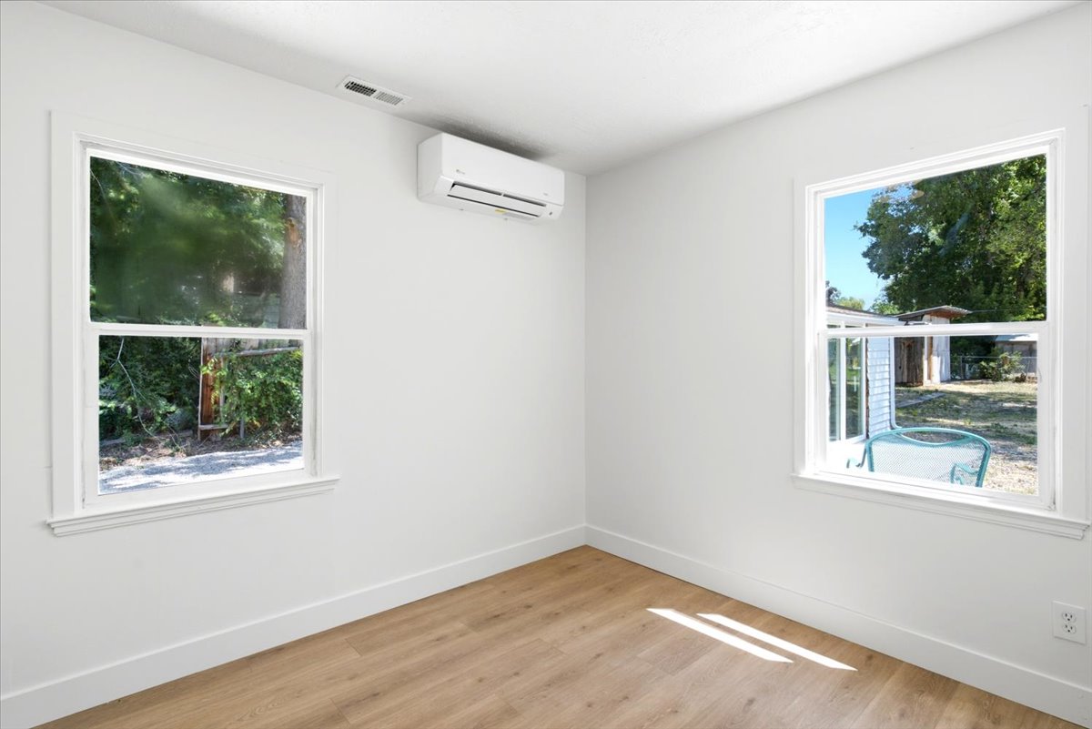 Bright interior space featuring wood-finish flooring and white baseboards