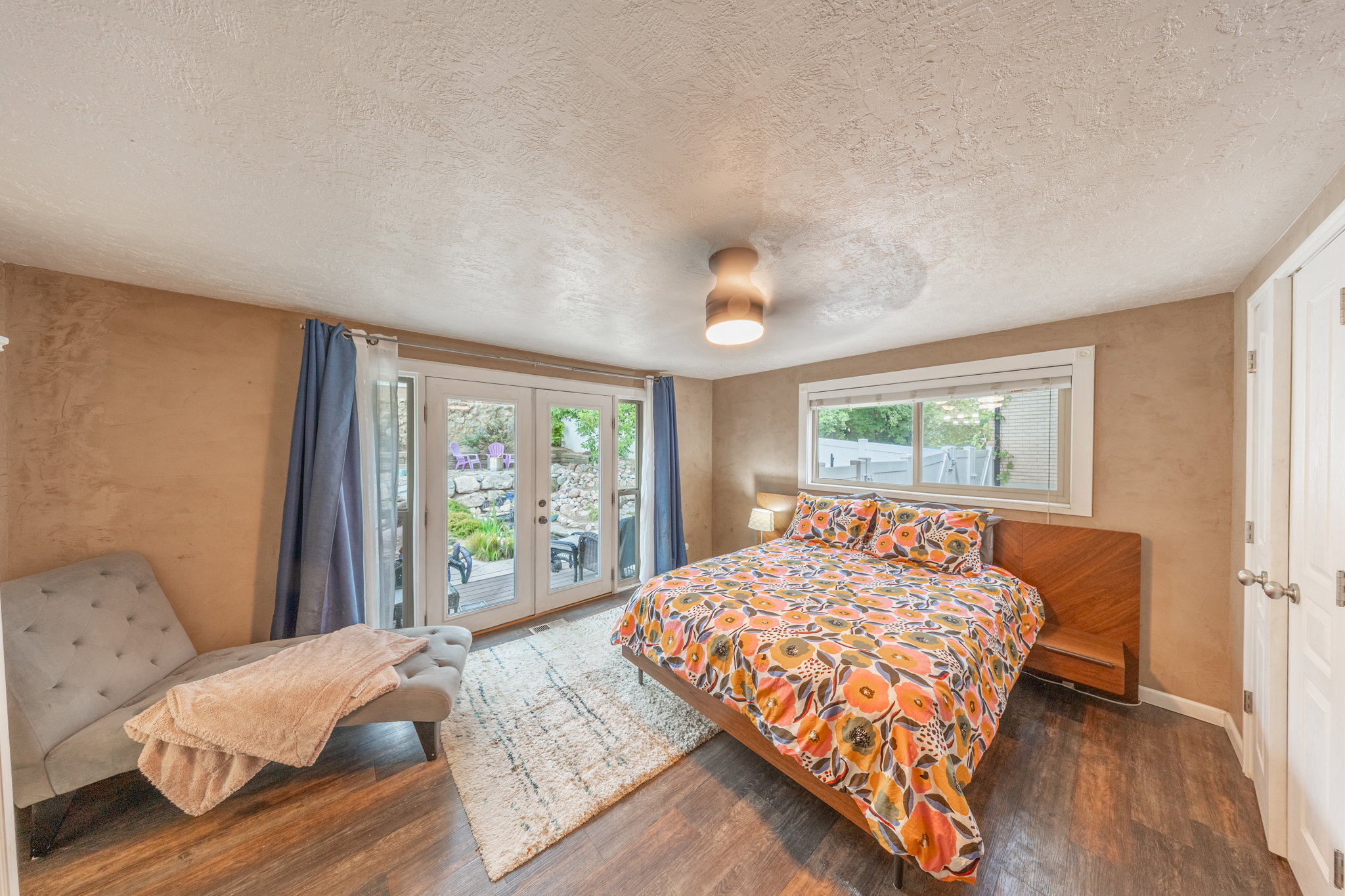 Primary suite with french doors out to patio and koi pond