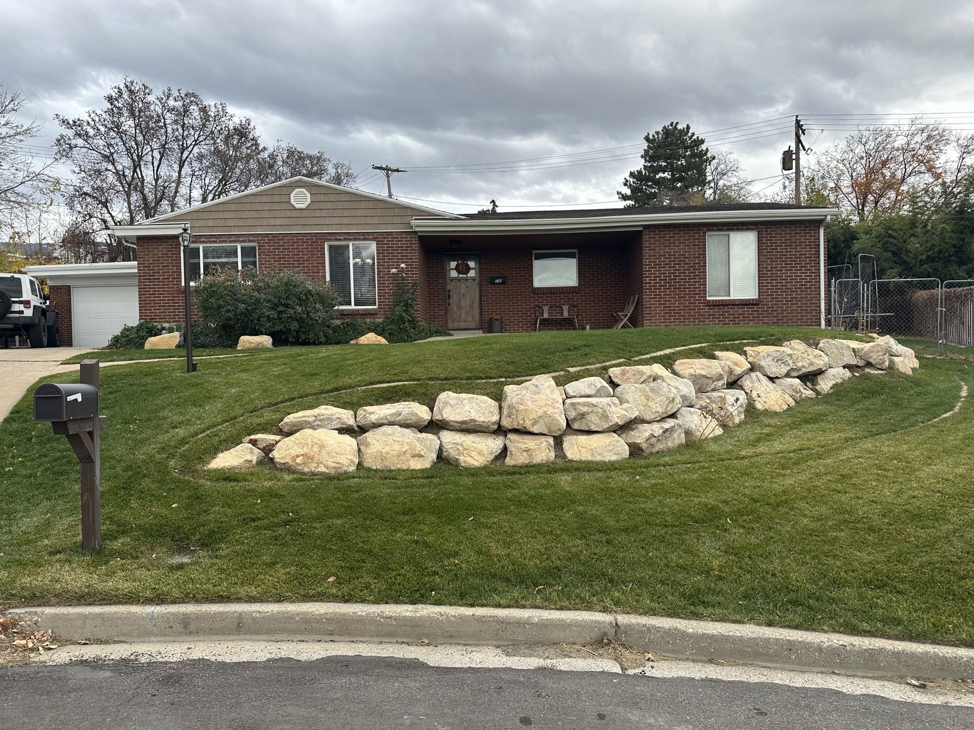 Brick exterior with a shingle accent gable and integrated garage