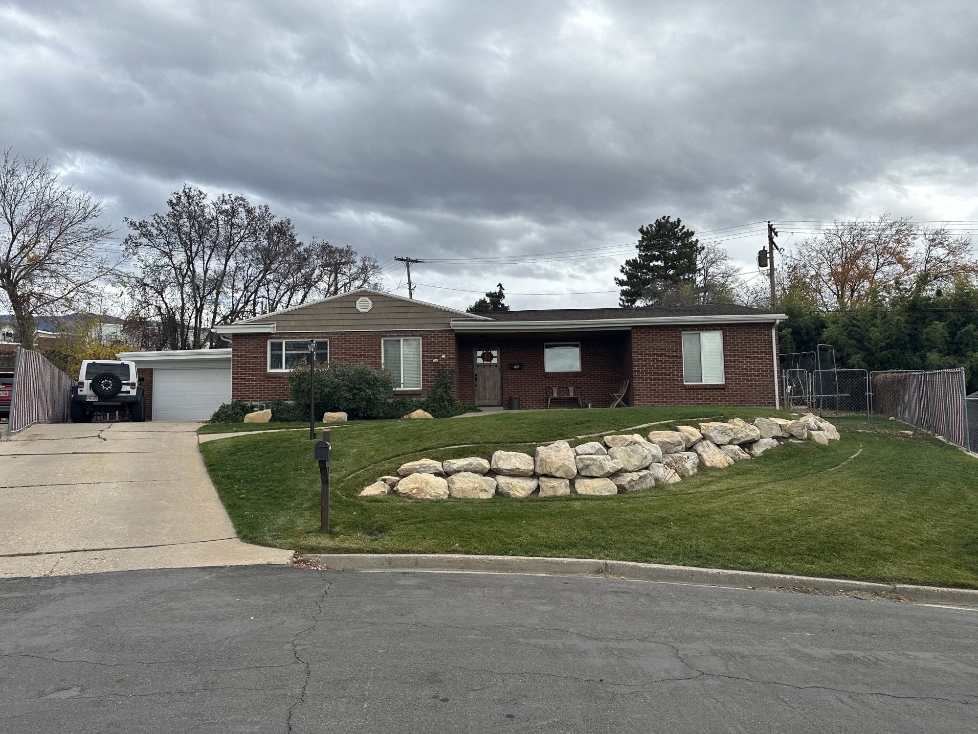 Brick exterior with a detached garage and concrete driveway