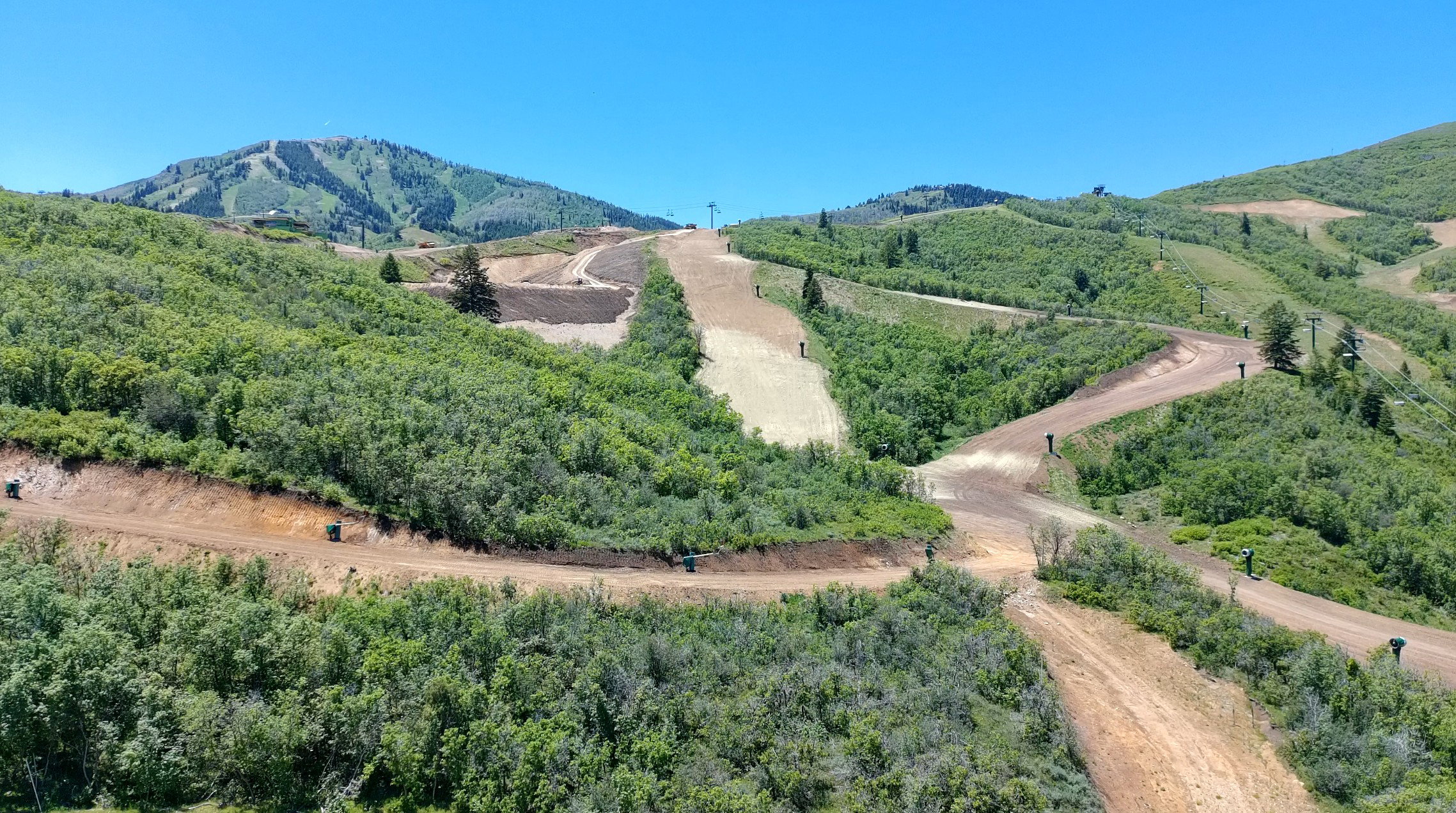 Expansive mountain landscape featuring varied terrain and lush green foliage