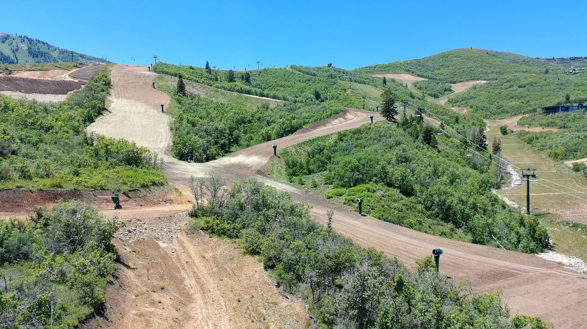 Mountainous terrain featuring ski slopes, forested areas, and ski lift infrastructure