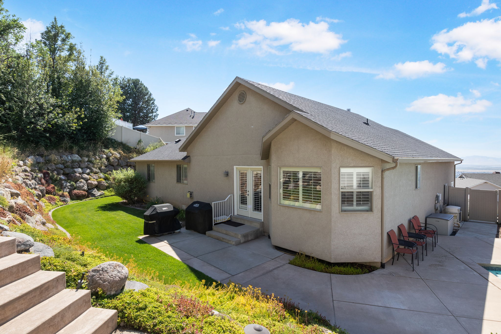 Exterior stucco finish with a dark shingle roof