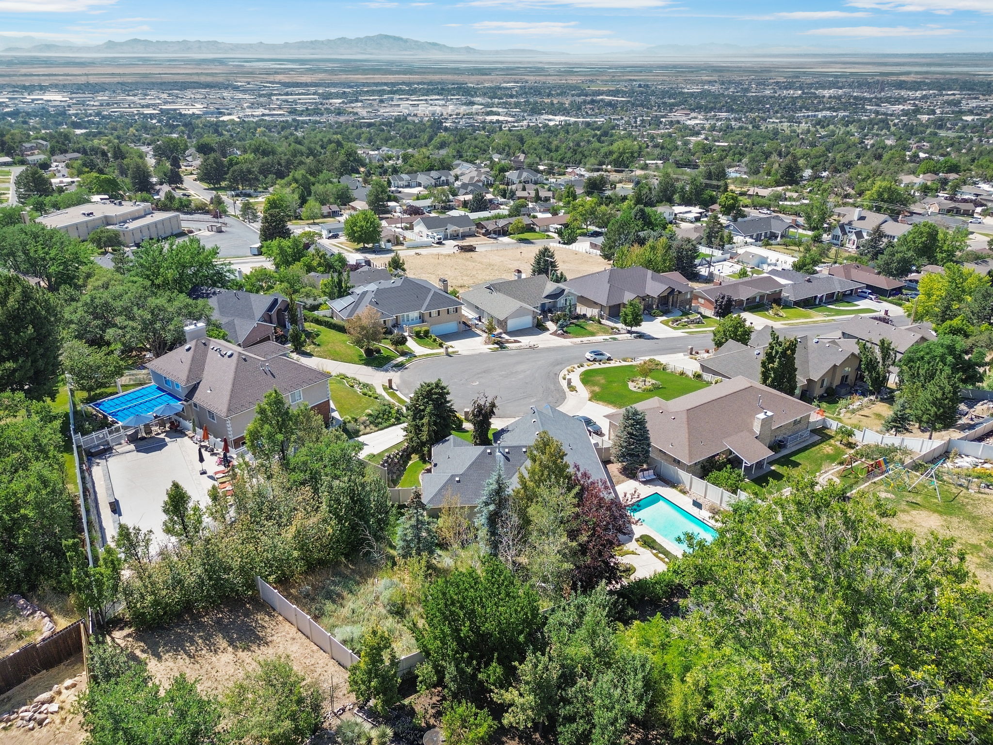 Aerial perspective showcasing a residential neighborhood with distant mountains