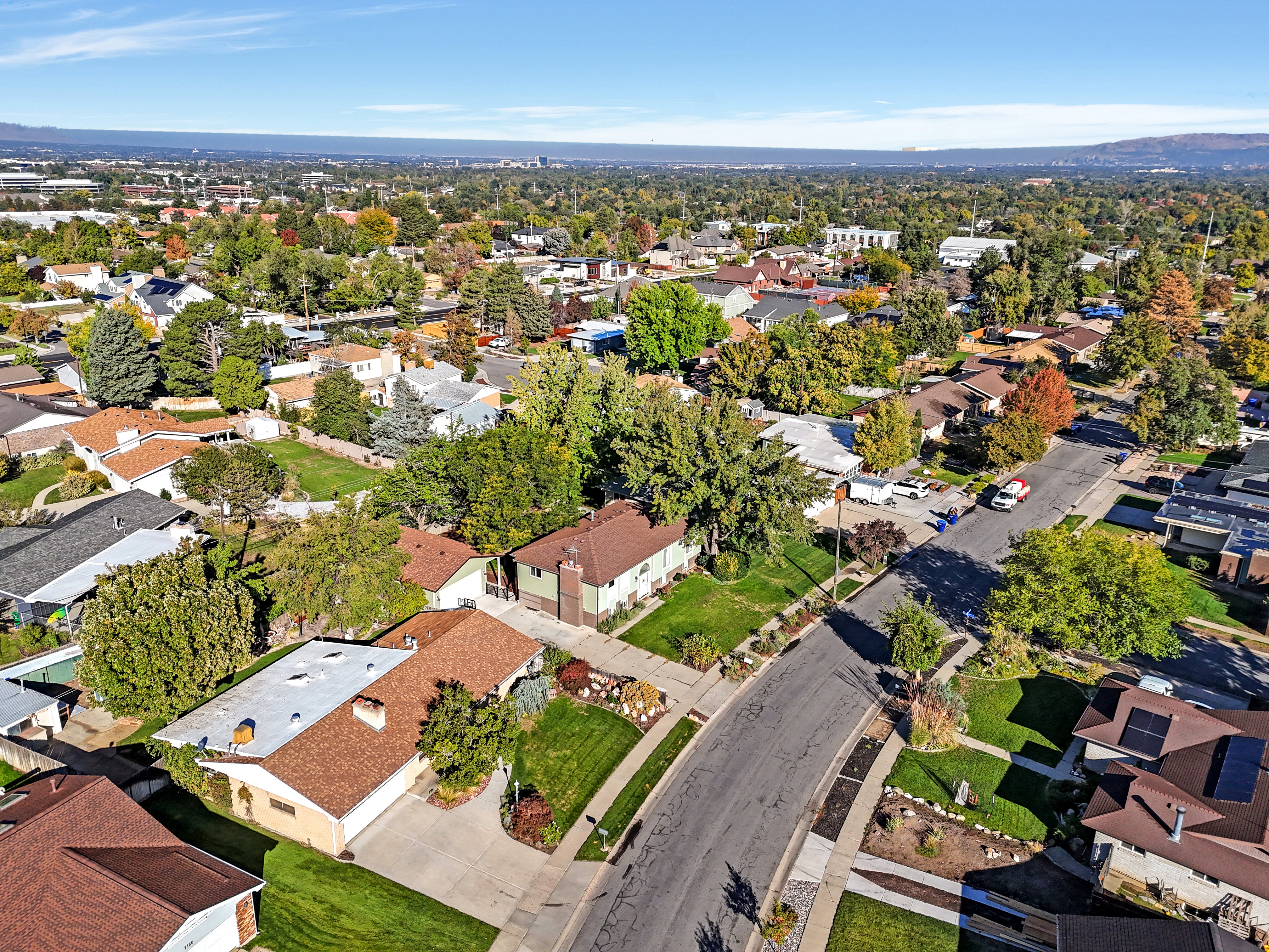 Aerial community overview featuring a network of residential properties and tree-lined streets