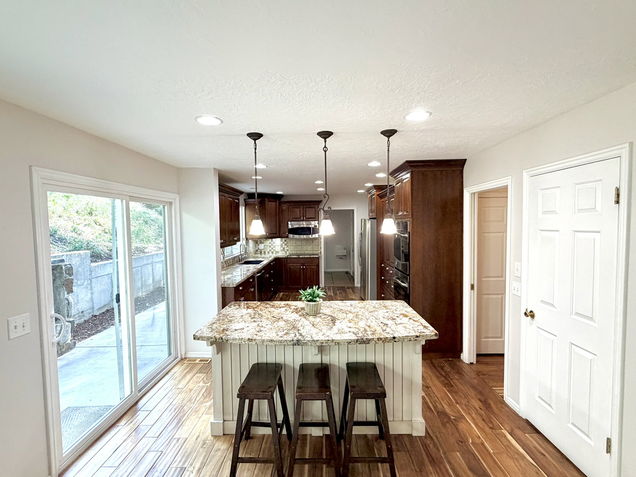 Kitchen featuring an island with a stone countertop and pendant lighting