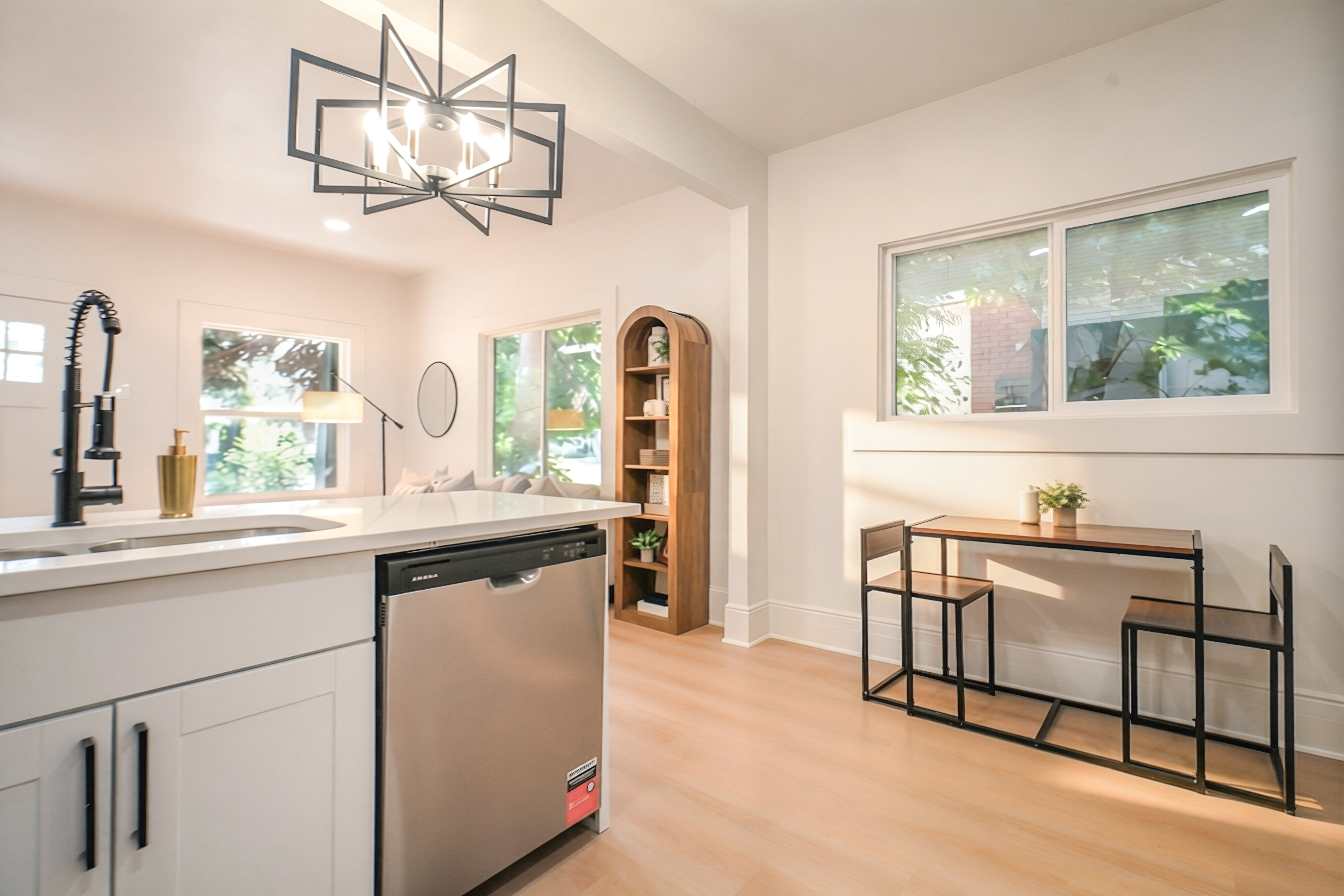 Kitchen island with an undermount sink, gooseneck faucet, and integrated stainless steel dishwasher