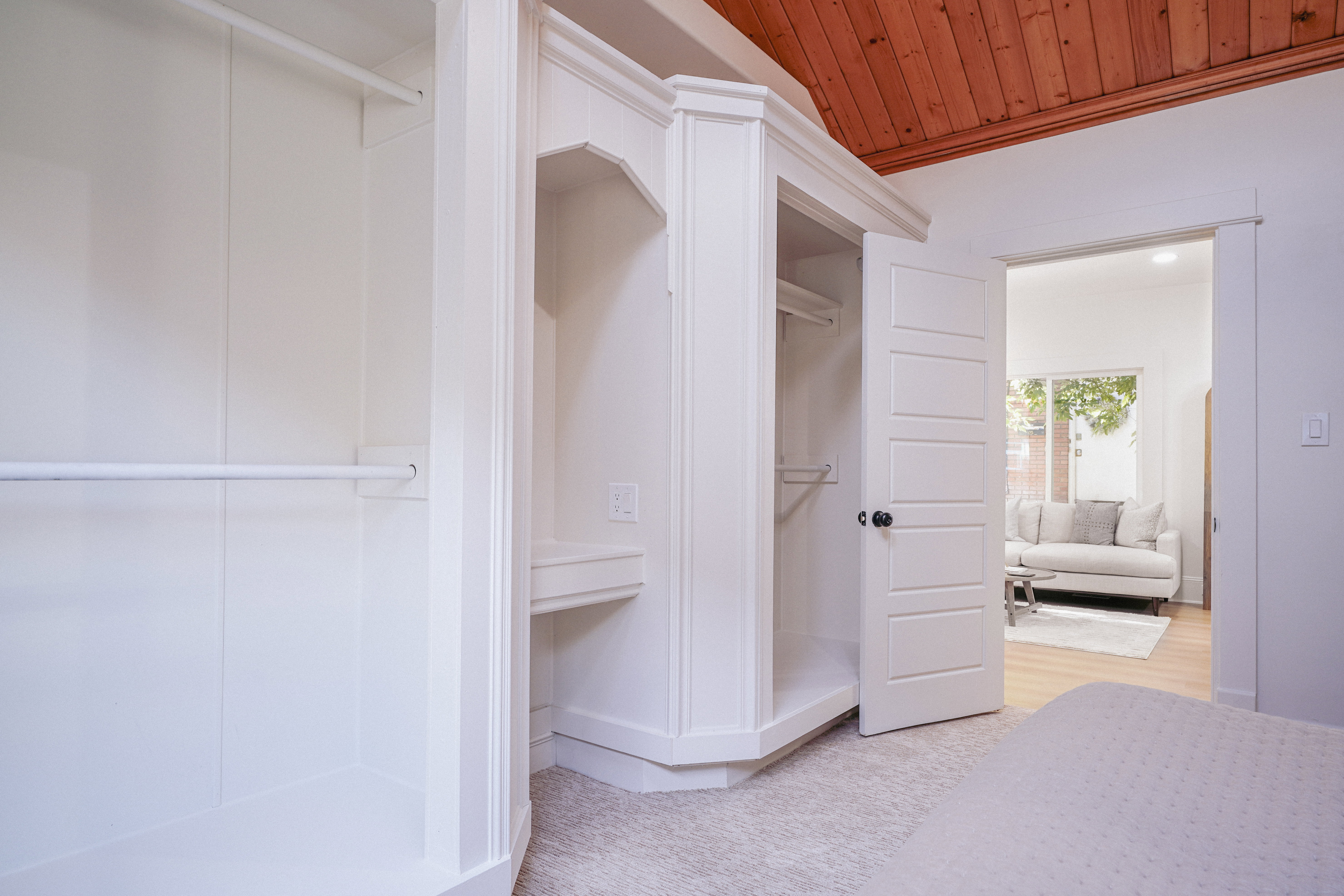 Built-in white cabinetry with hanging rods and shelving