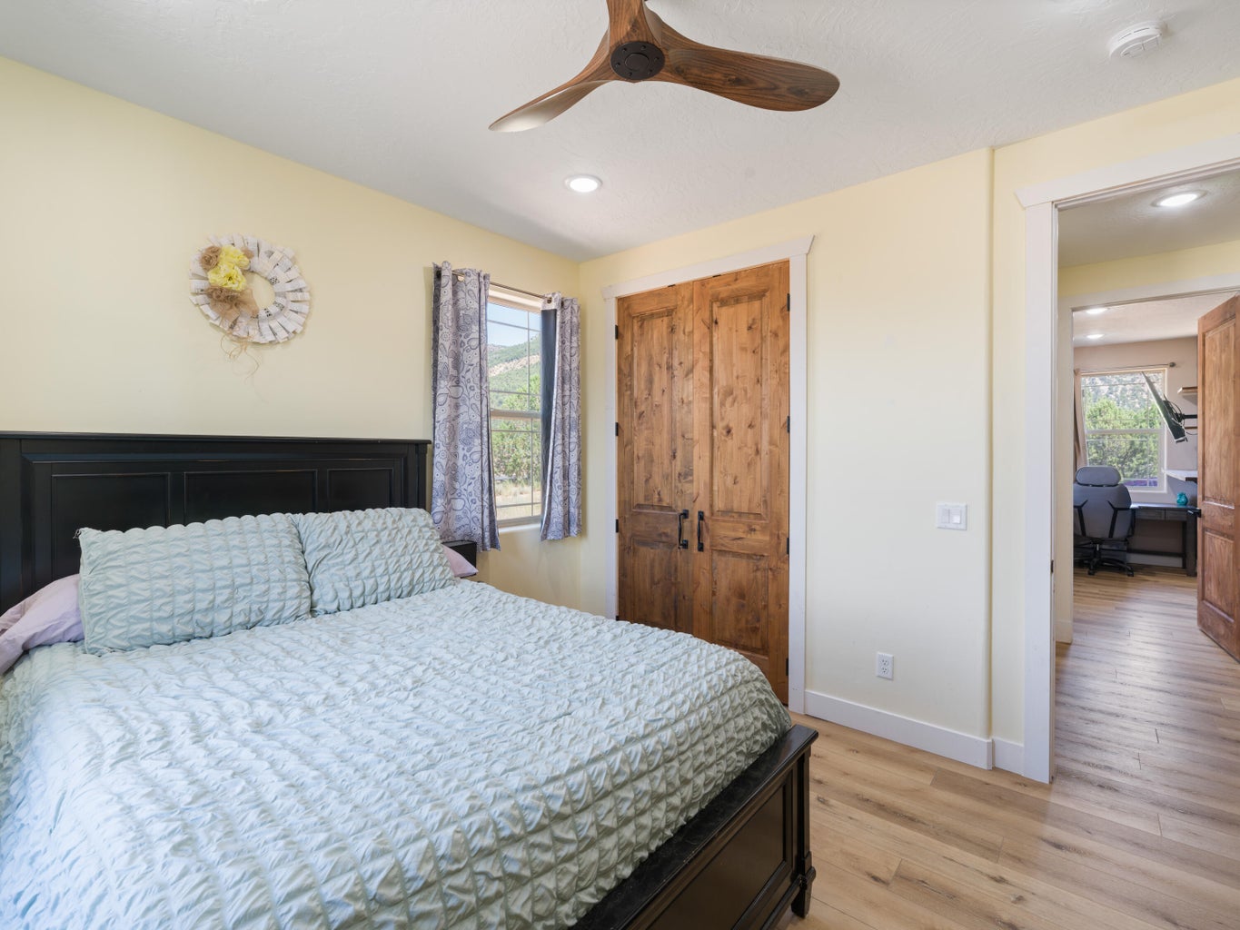 Bedroom featuring wood-finish flooring, a rustic wood ceiling fan, and recessed lighting