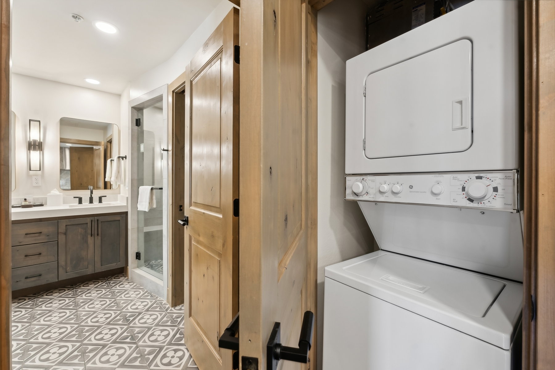 Bathroom featuring a dark wood-finish vanity with a white countertop and a walk-in shower with a glass enclosure