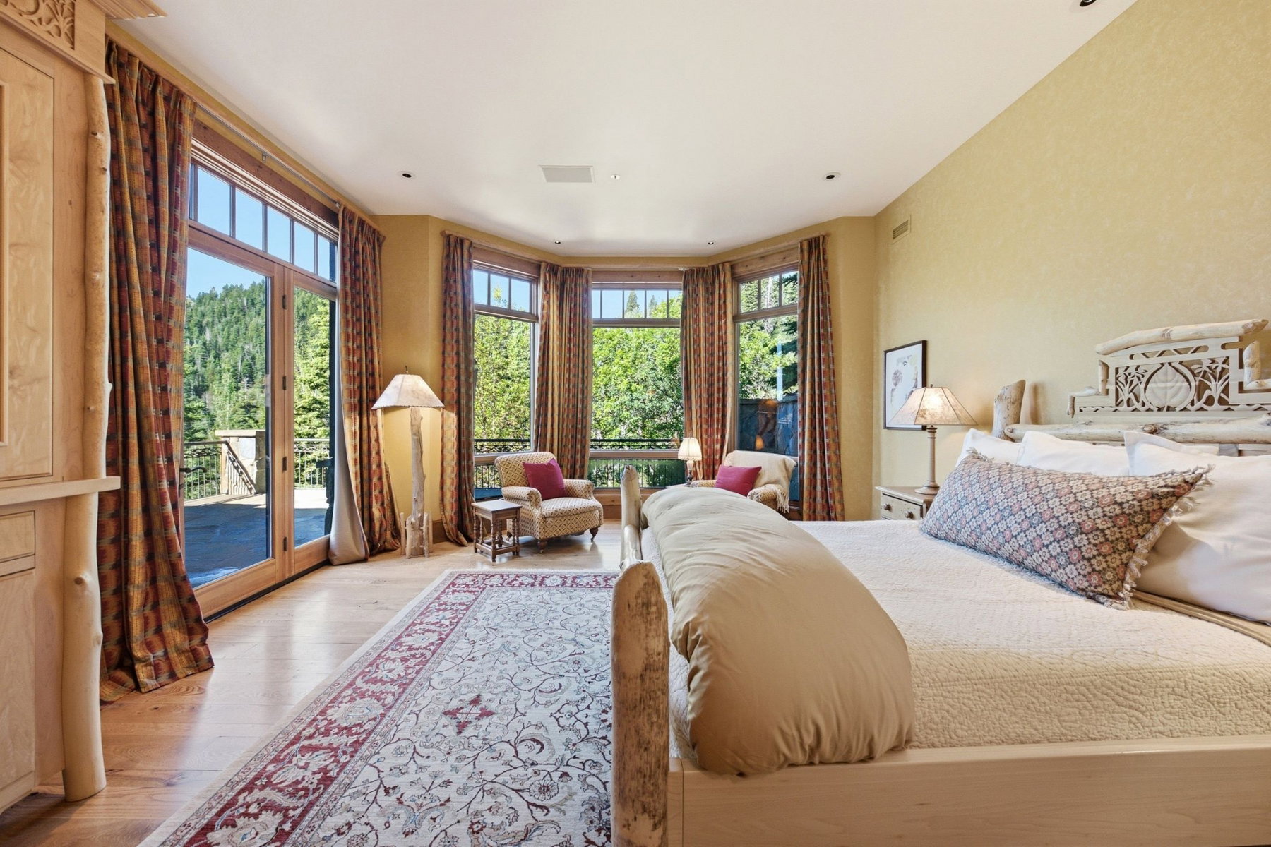 Hardwood flooring throughout featuring a large area rug