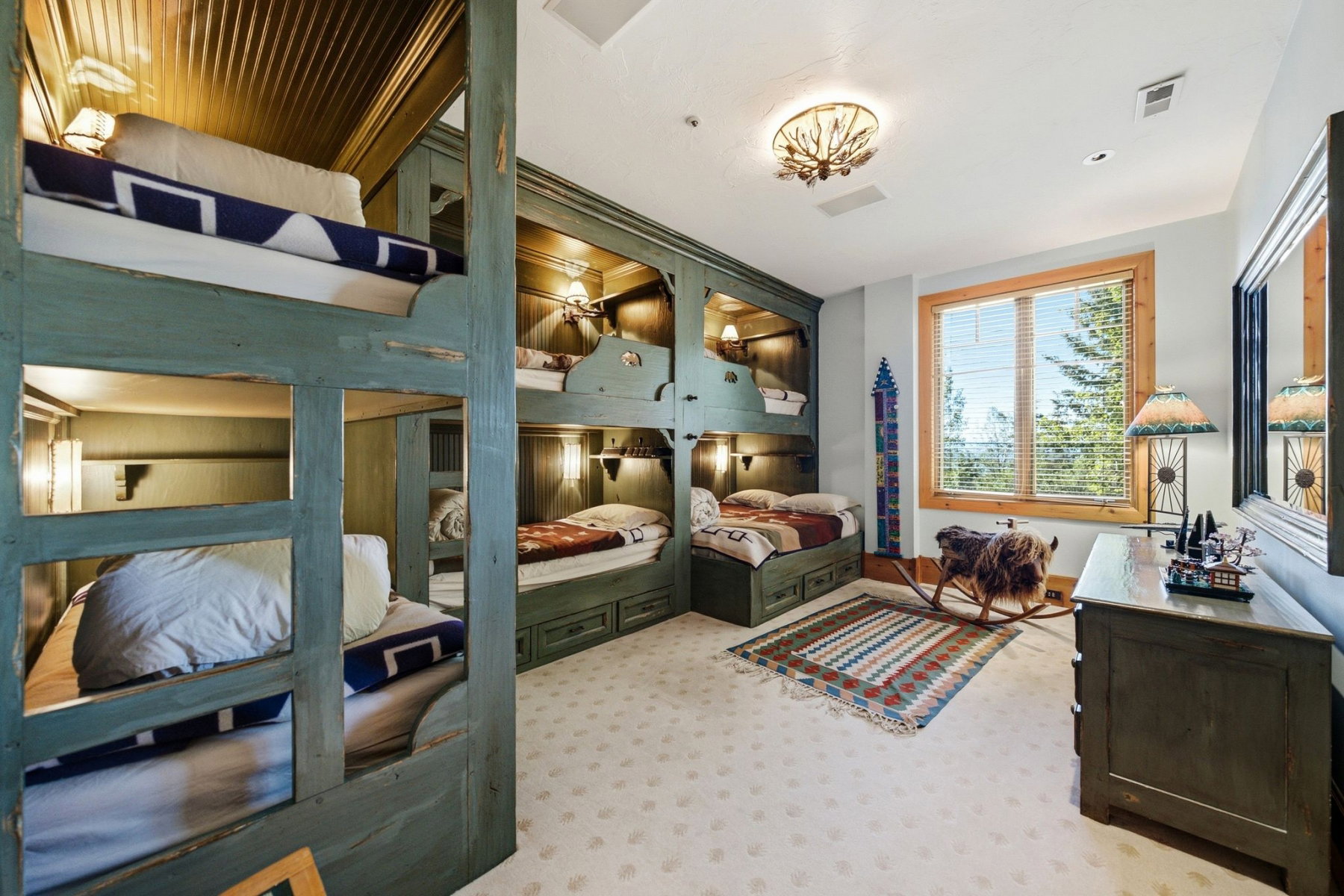 Custom built-in bunk beds with individual lighting fixtures and integrated storage drawers