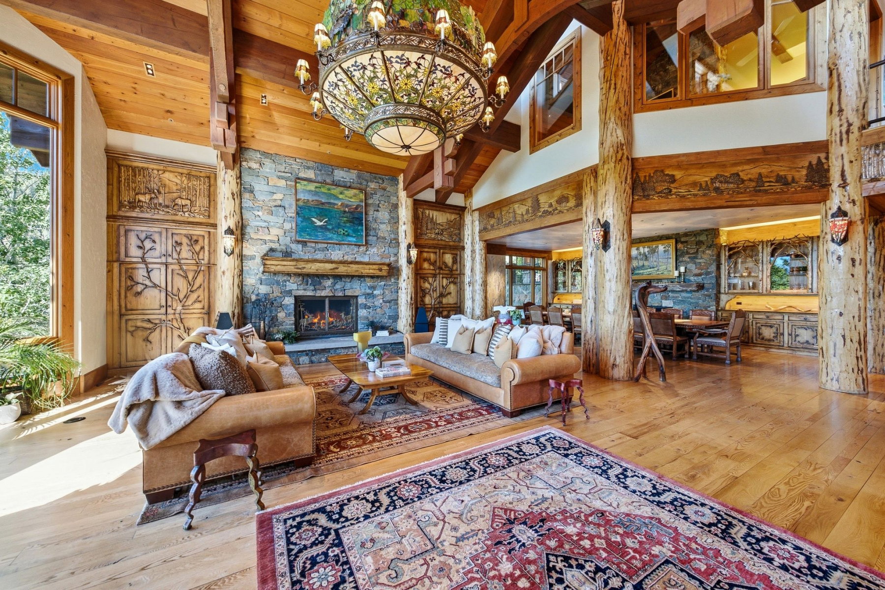 Expansive living area featuring a vaulted wood-paneled ceiling with exposed beams