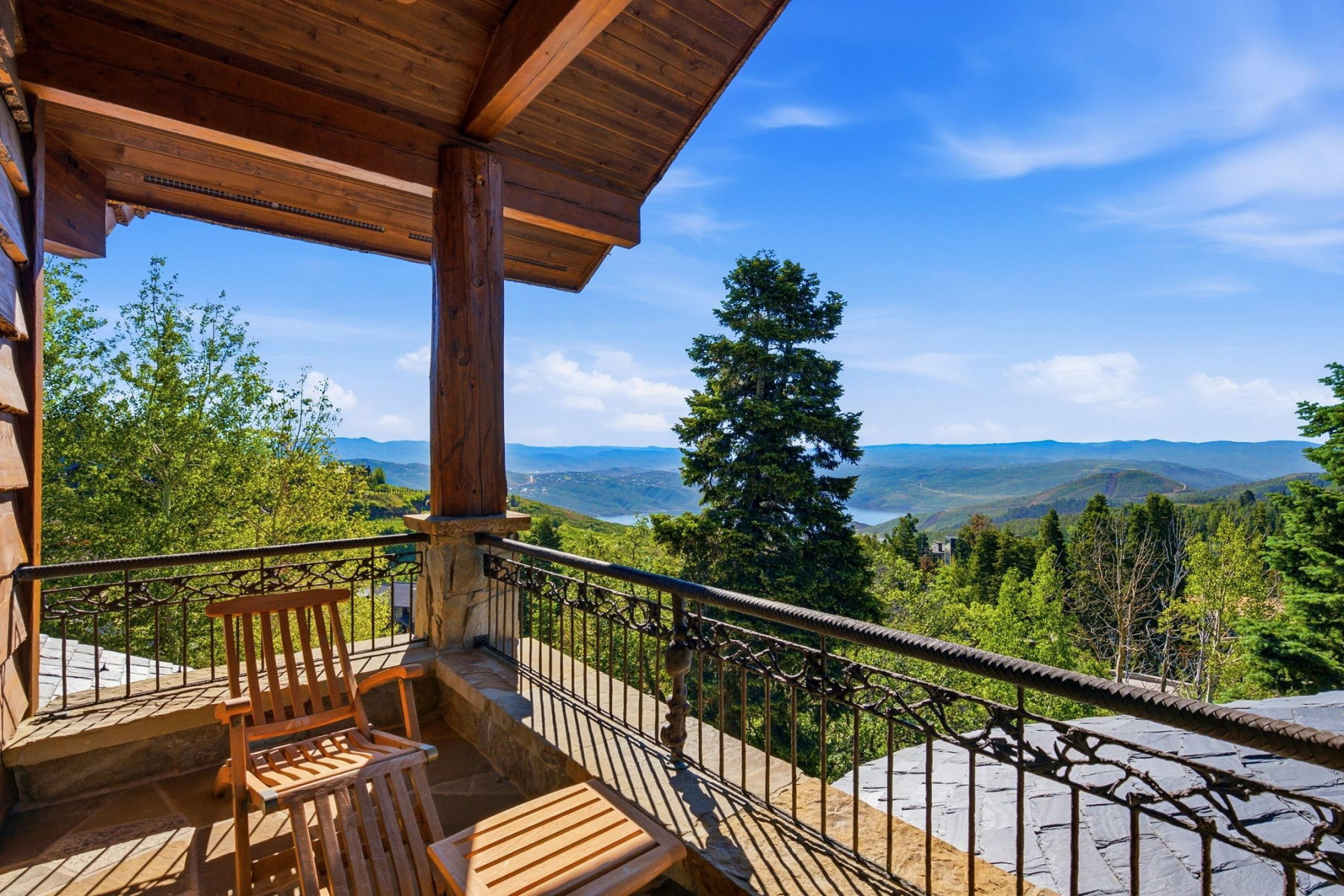 Covered balcony featuring wood-beam construction and a stone pillar