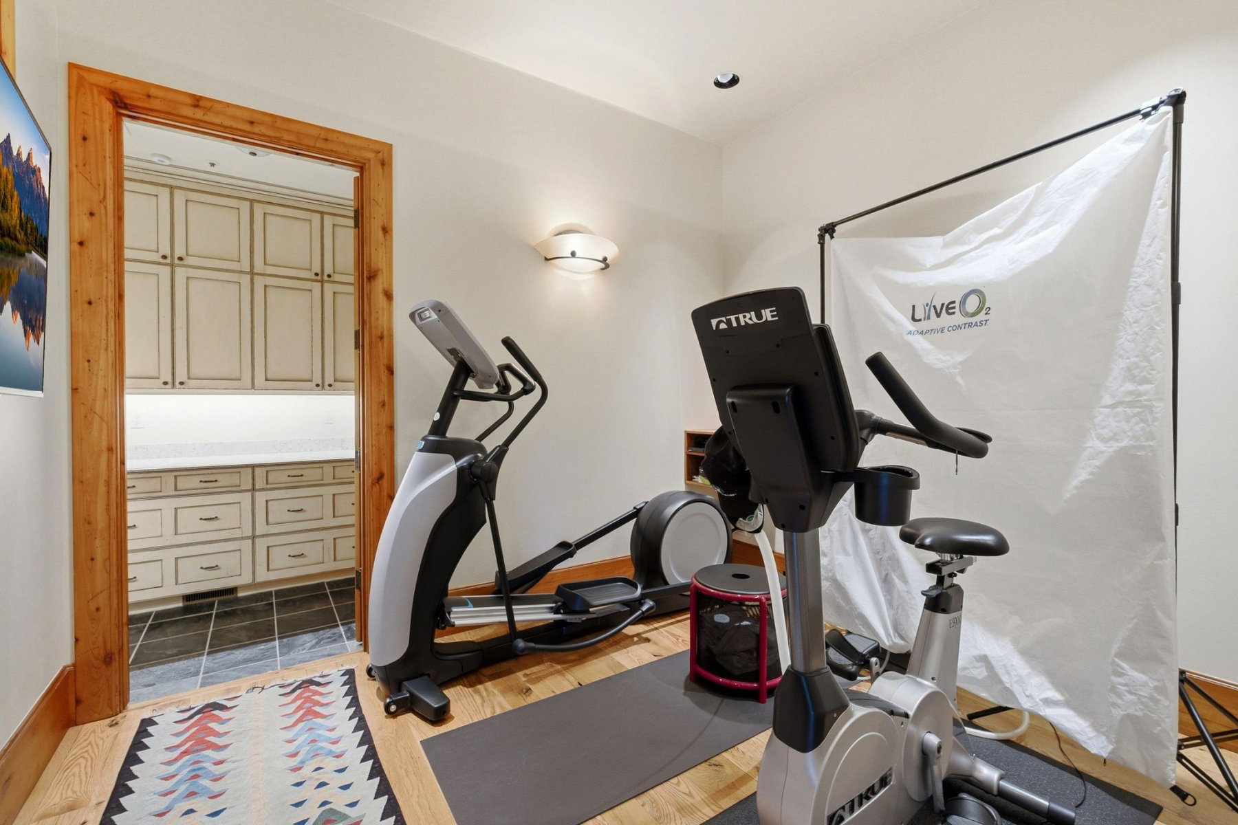 Dedicated recreation area with hardwood flooring and recessed lighting