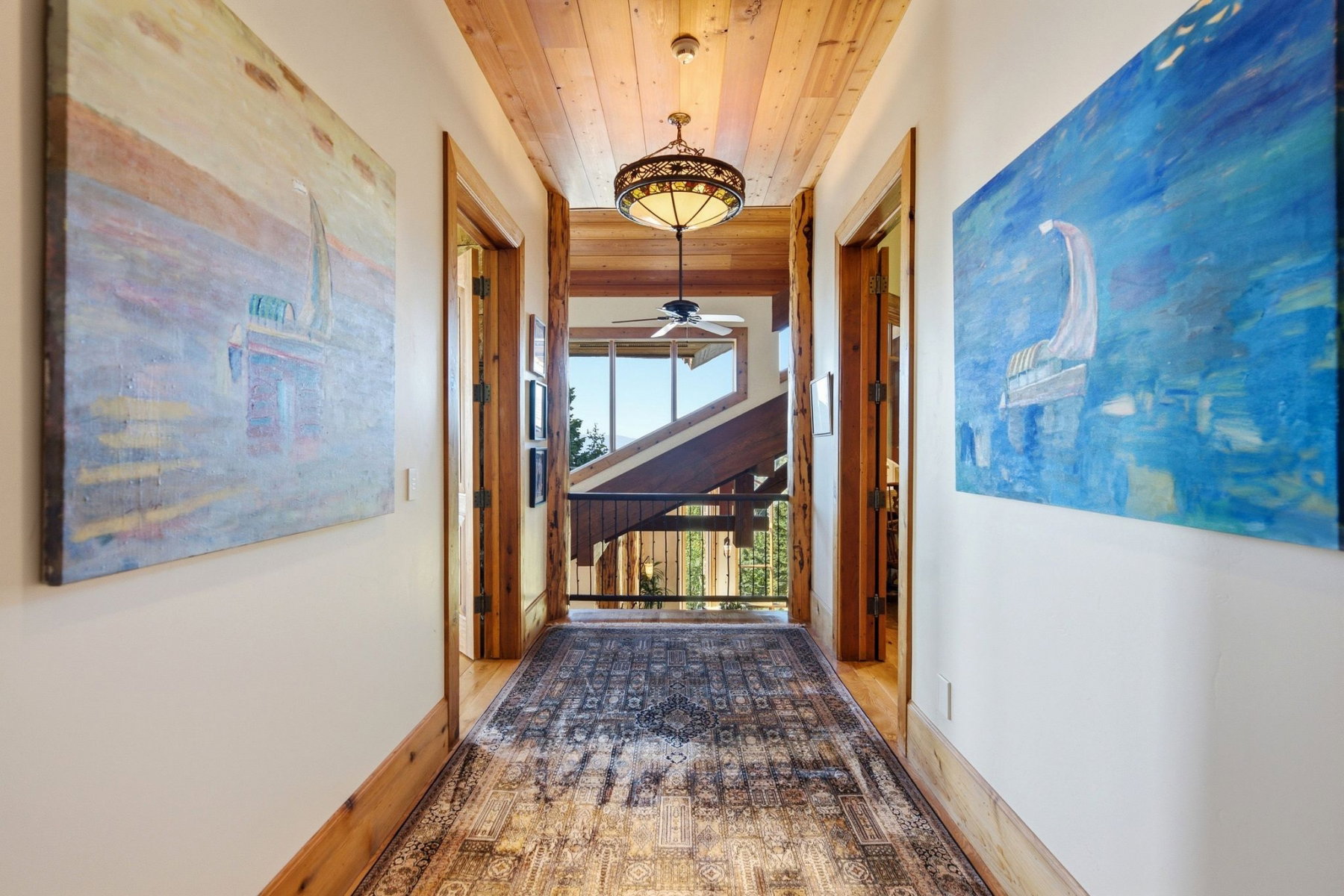 Hallway featuring a natural wood plank ceiling, light-toned walls, and wood trim