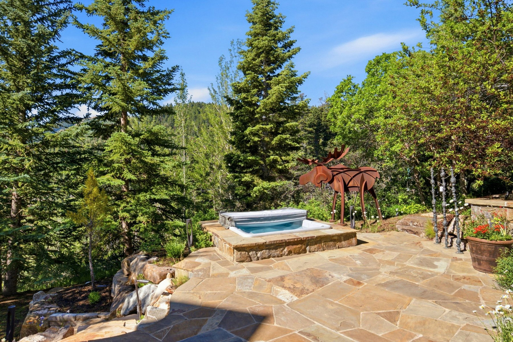 Flagstone patio featuring a built-in hot tub with stone surround