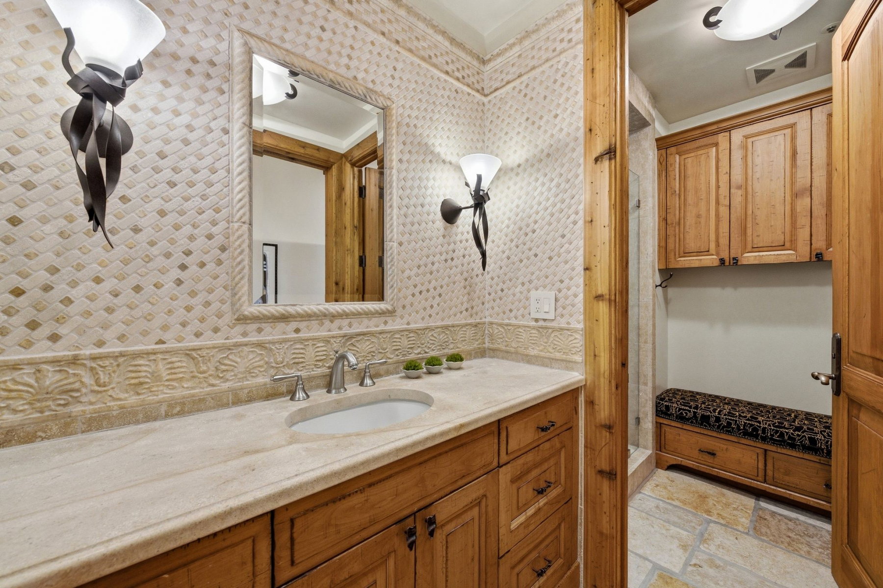 Bathroom featuring a custom wood vanity with a stone countertop and integrated sink