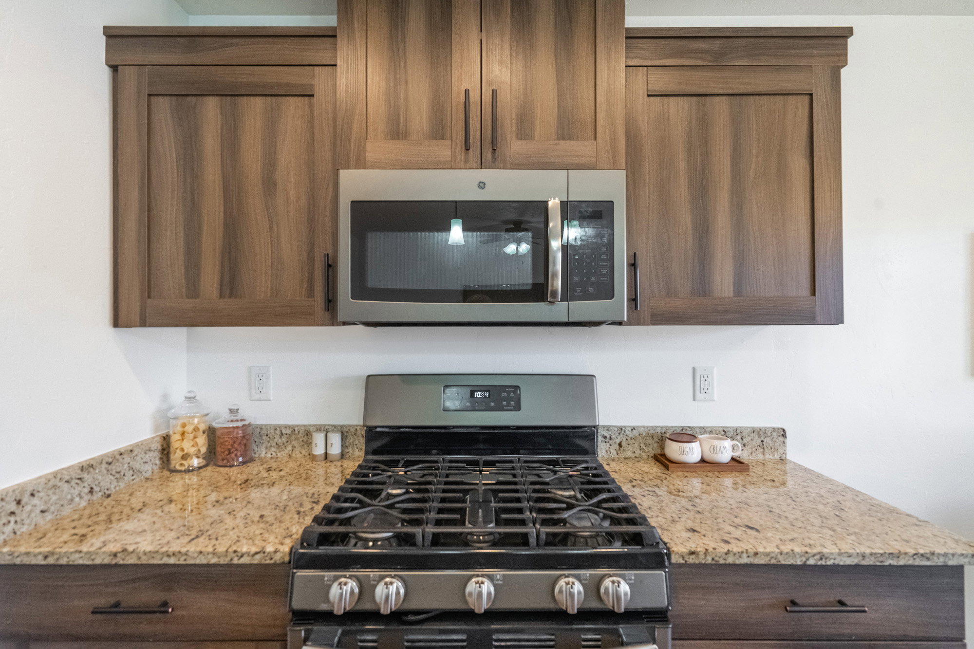 Stainless steel gas range with coordinating microwave