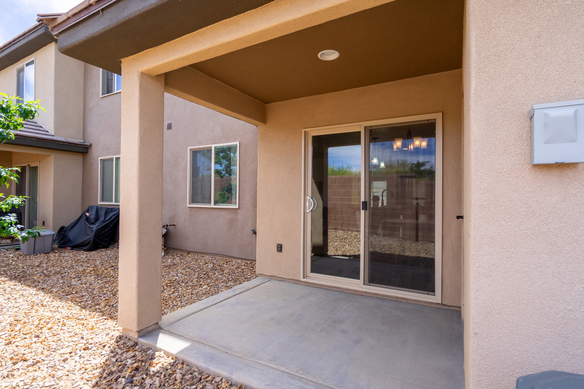 Covered patio featuring a concrete slab and direct access to the interior via a sliding glass door