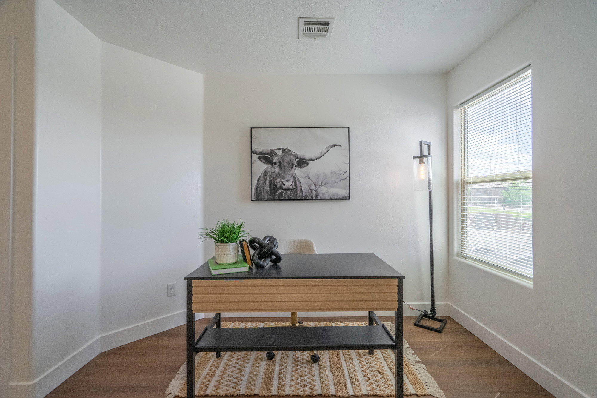 Room with a large window and wood-finish flooring
