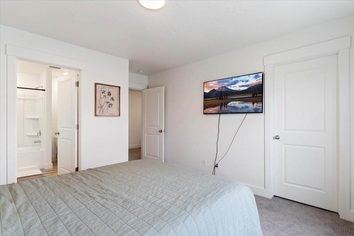 Bedroom with white walls and gray carpet flooring