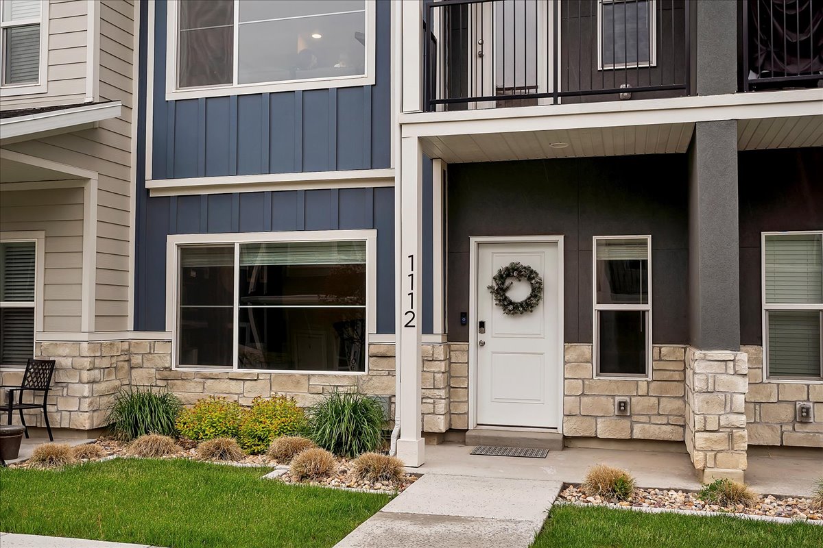 Modern facade featuring a combination of horizontal siding, vertical board and batten, and stone veneer accents