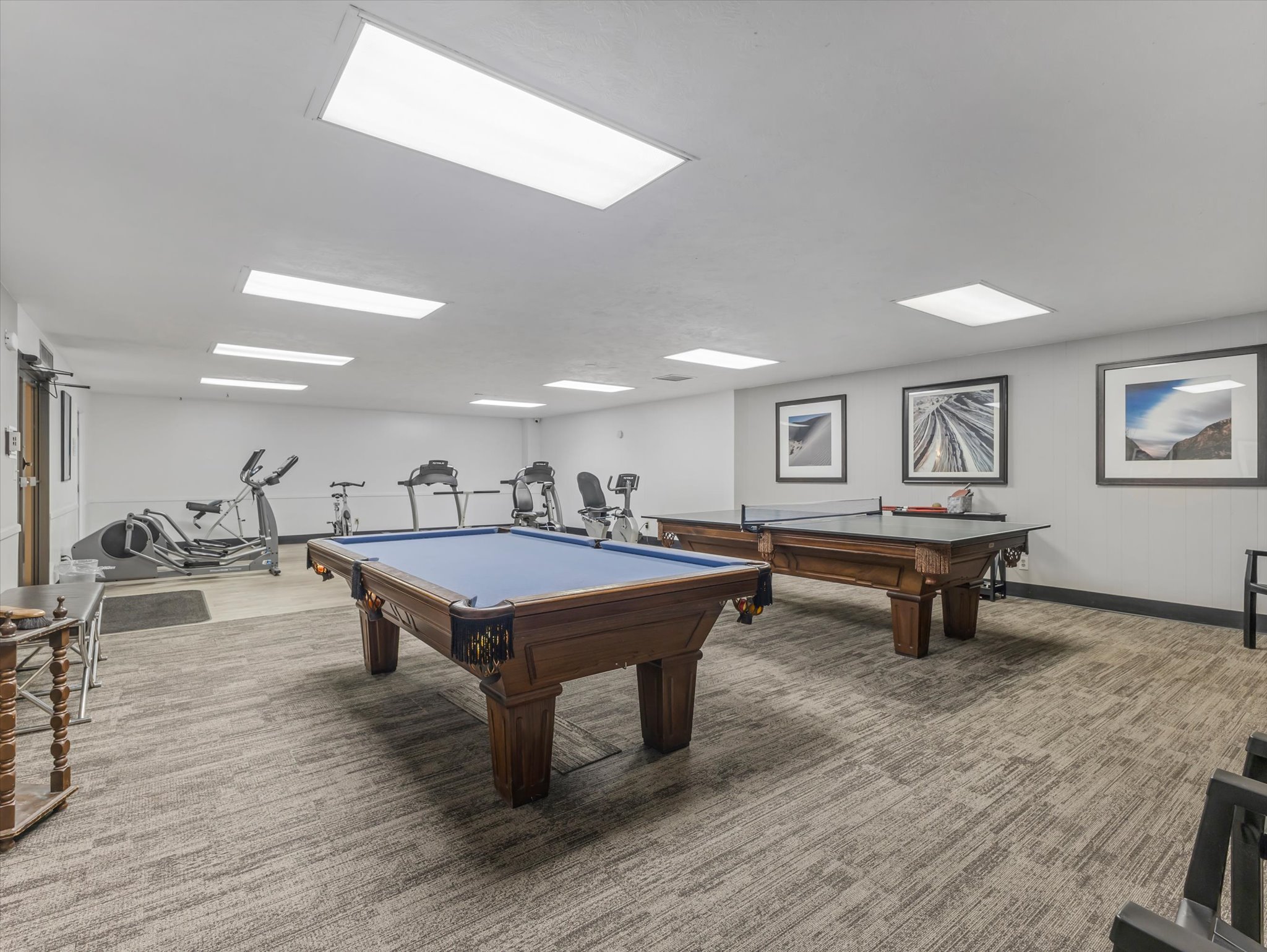 Recreational space featuring a billiard table, ping pong table, and various exercise equipment