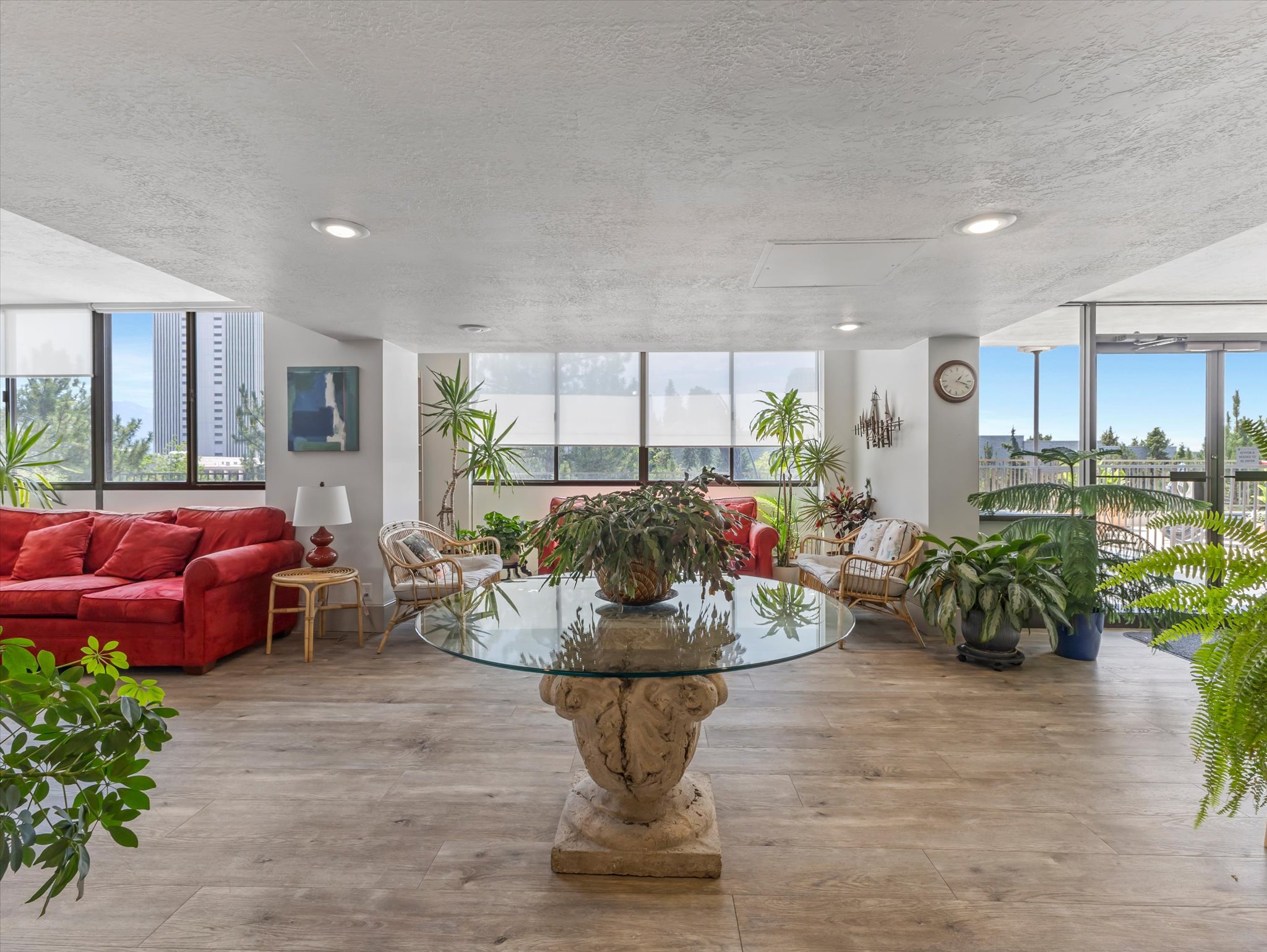 Spacious common area featuring wood-finish flooring, recessed lighting, and expansive windows