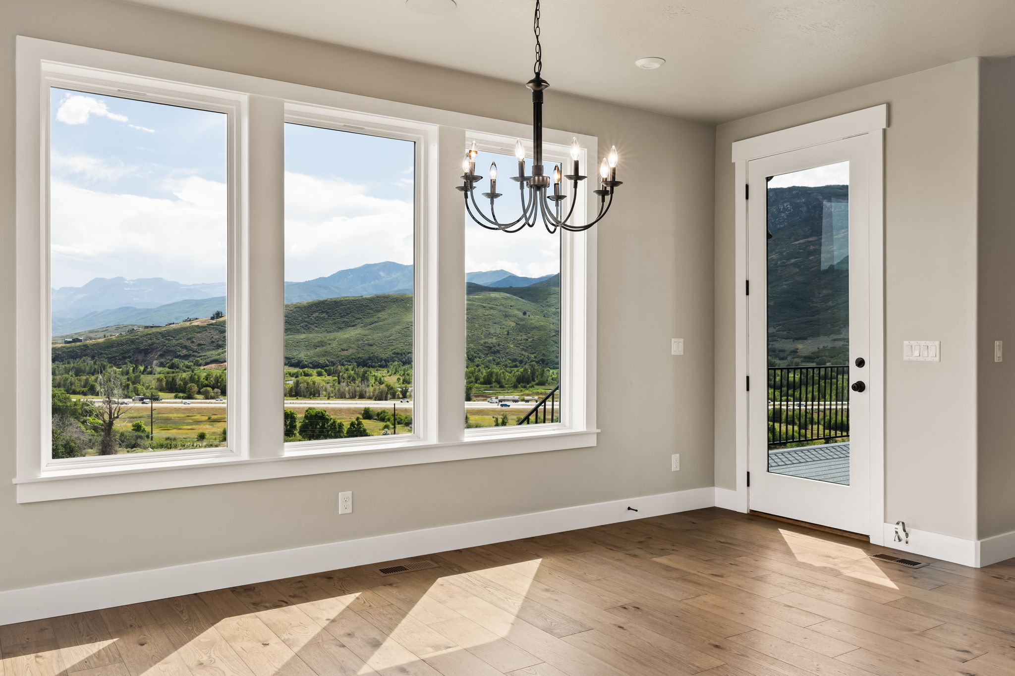 Spacious room with large windows showcasing natural scenery