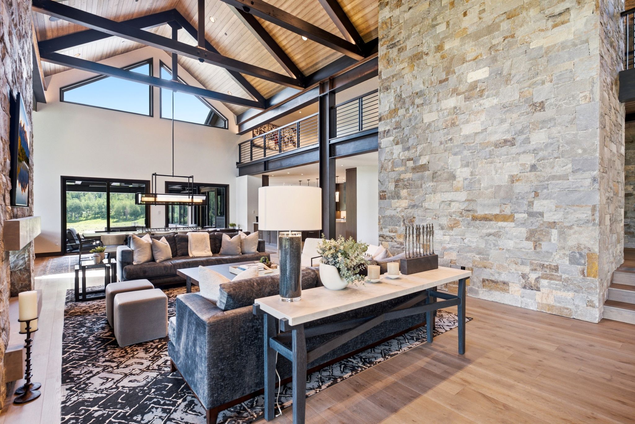 Vaulted ceilings with exposed wood beams and architectural windows
