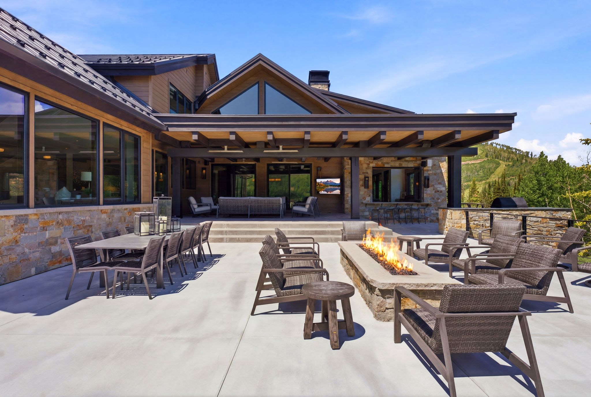 Expansive concrete patio featuring an integrated linear fire pit